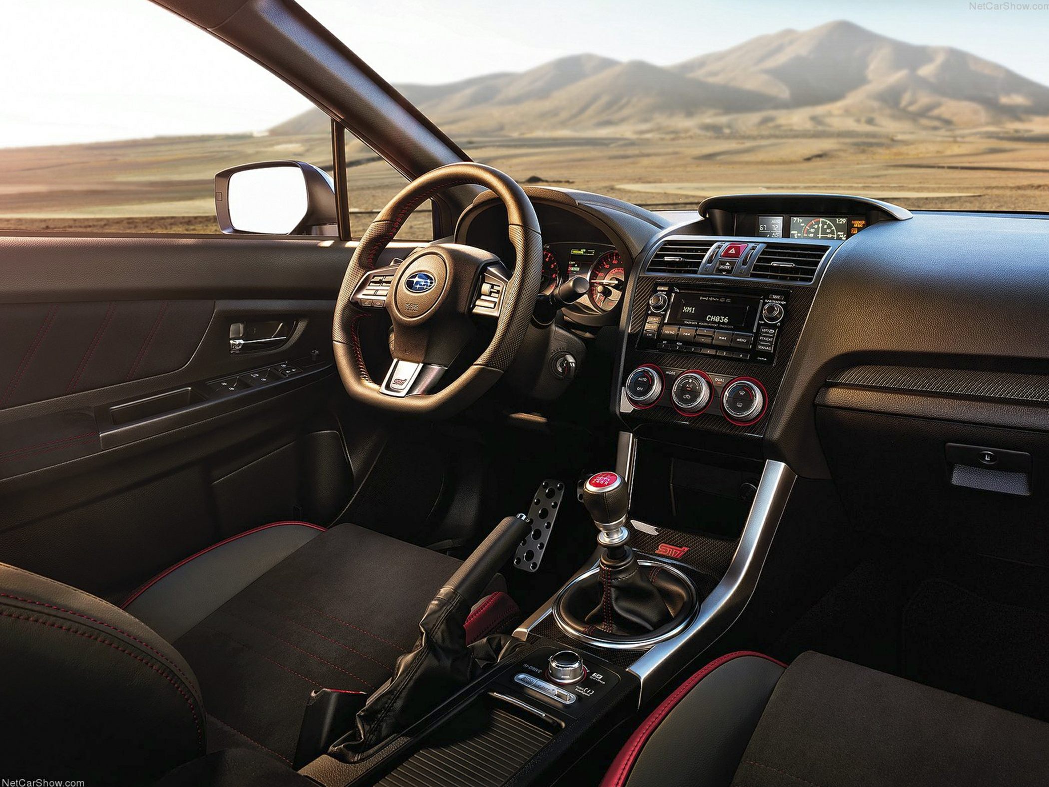 Manual transmission, sport steering wheel, center console with STI badge