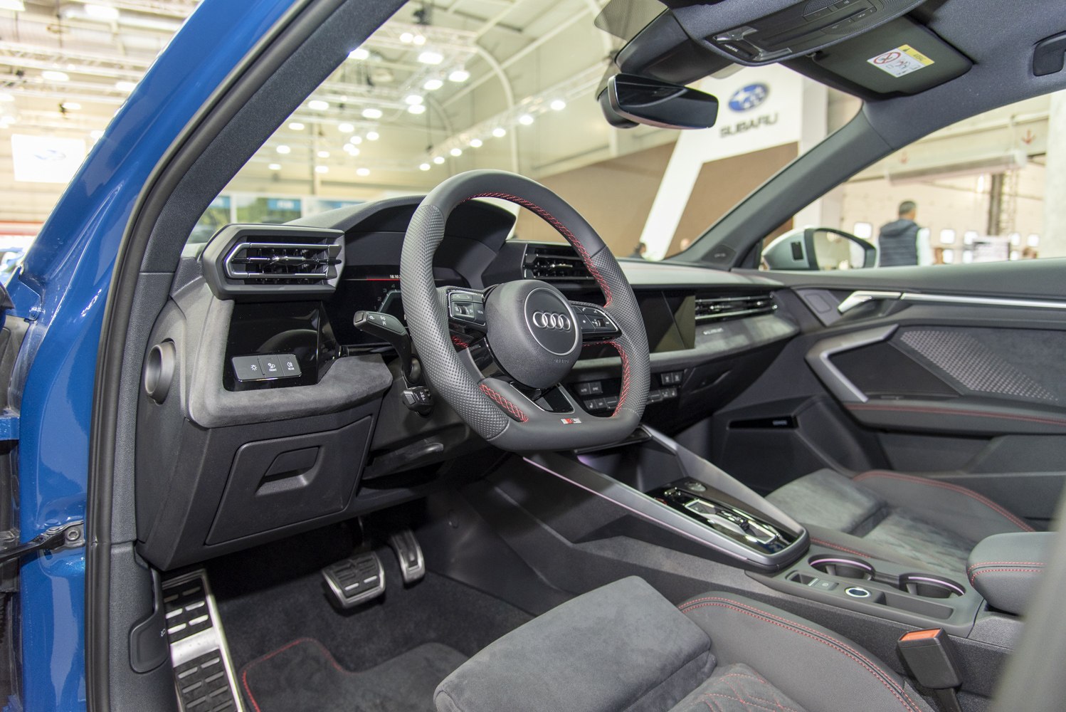 Sporty steering wheel and modern interior details with red stitching