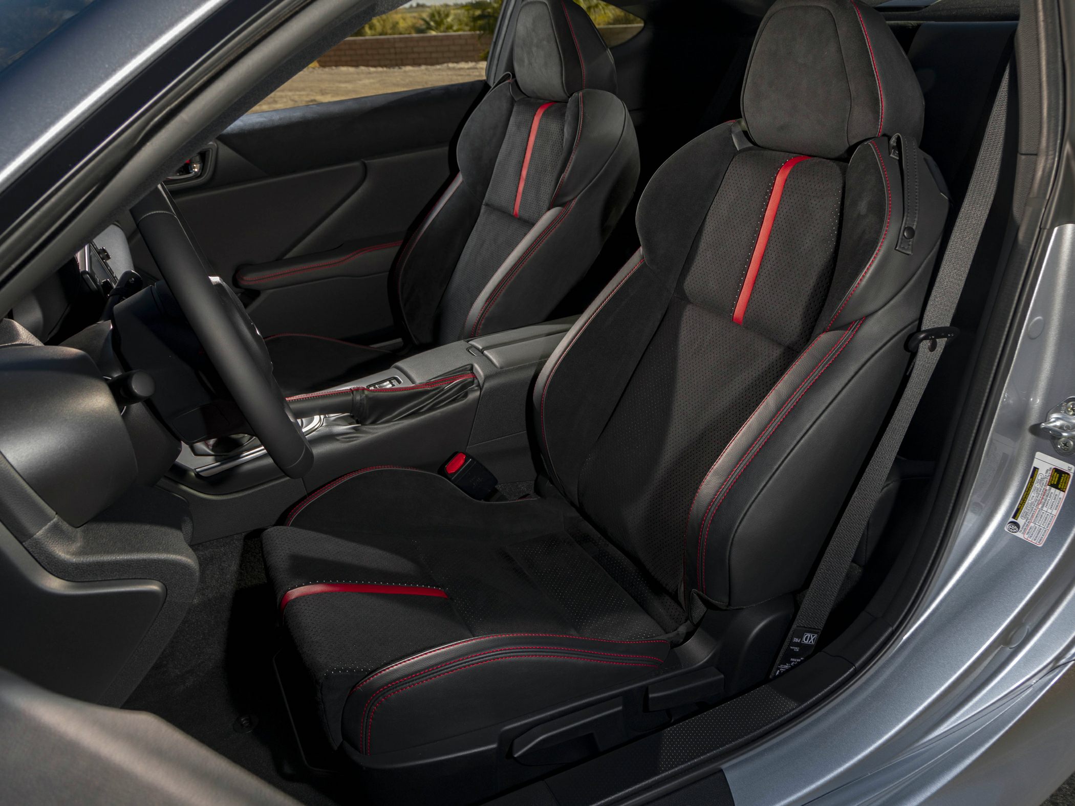Sporty black and red racing style front seats with textured upholstery