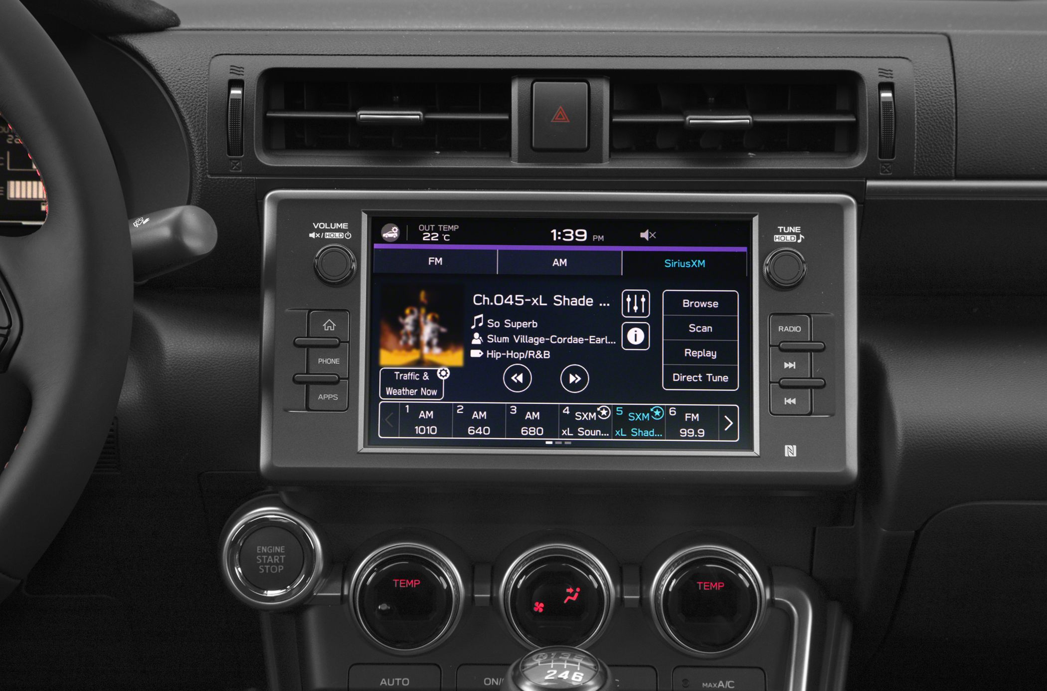 Car dashboard with touchscreen infotainment and climate control knobs