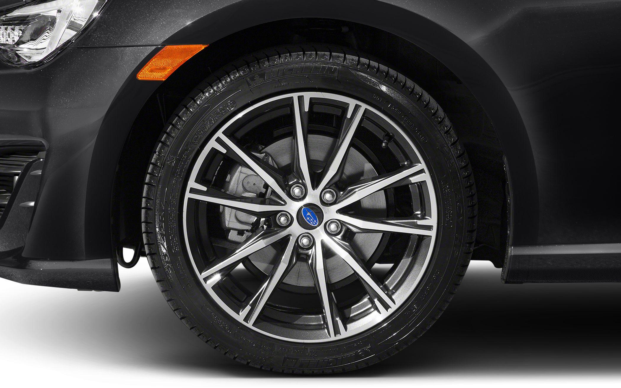 Multi-spoke alloy wheel and tire with brake disc behind.