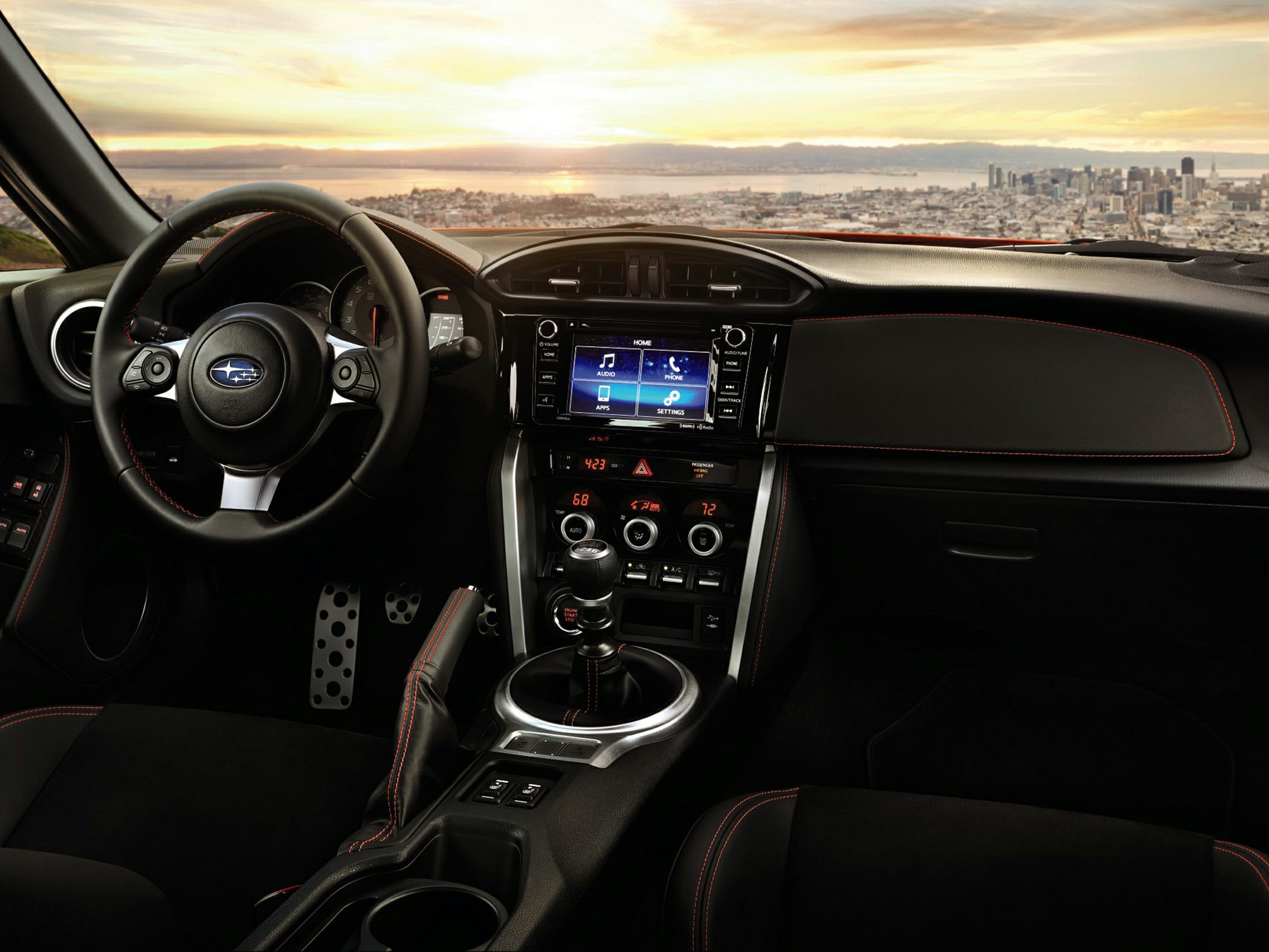 Detailed interior with manual gear shift and touchscreen infotainment system.