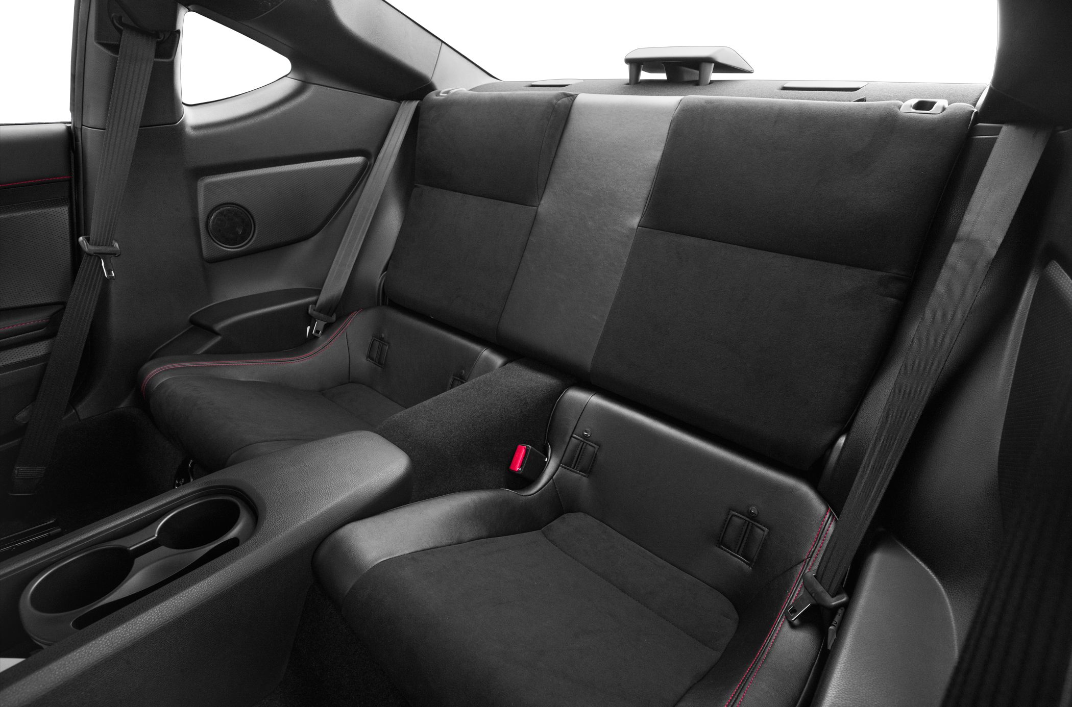 Rear seating interior with black upholstery, red stitching, and cup holders
