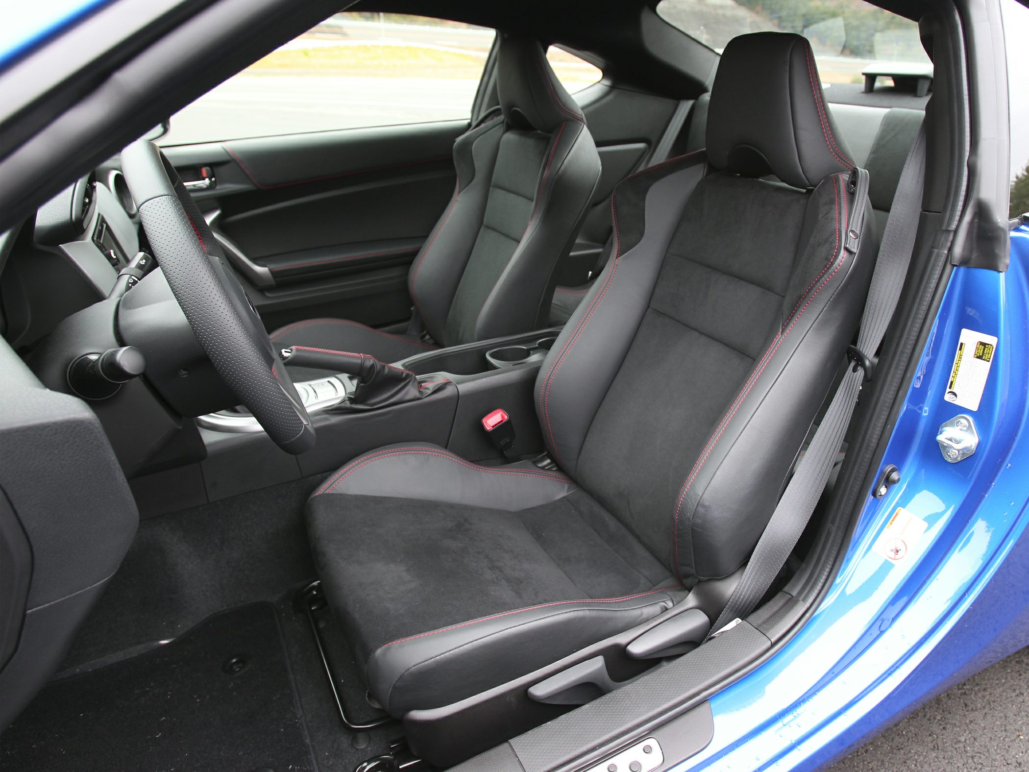 Sporty black leather and Alcantara interior seats with red stitching.
