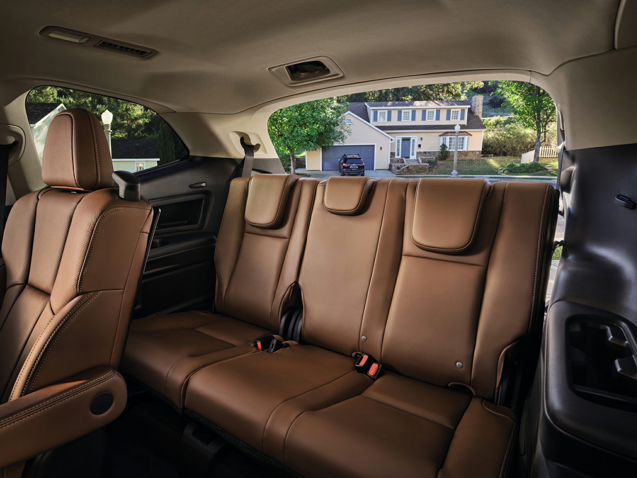 Third-row brown leather seating with headrests and seat belts