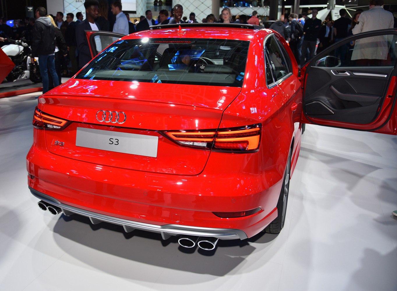 Red car rear with LED taillights and quad exhaust pipes