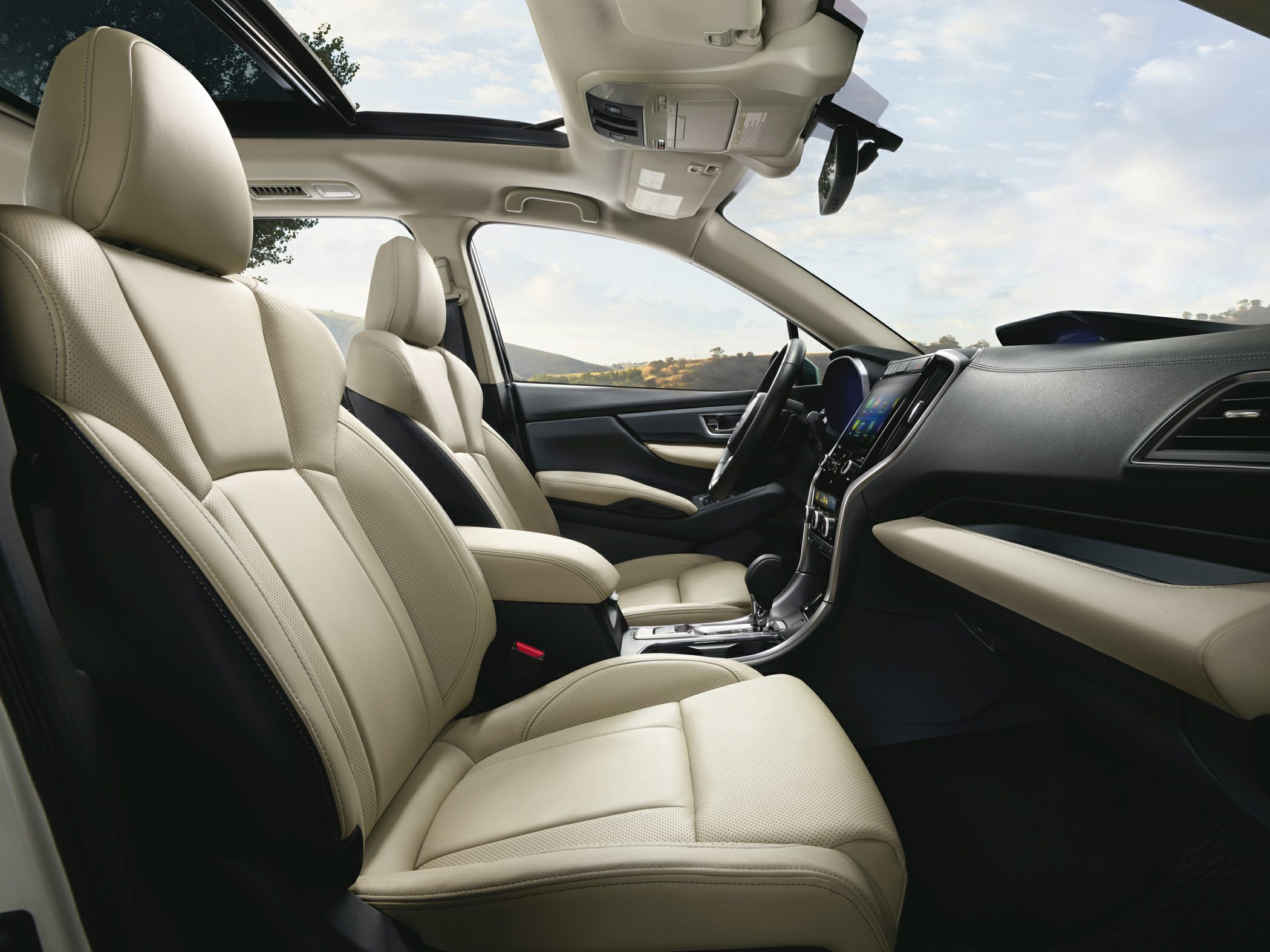 Beige leather front seats with panoramic sunroof and modern dashboard