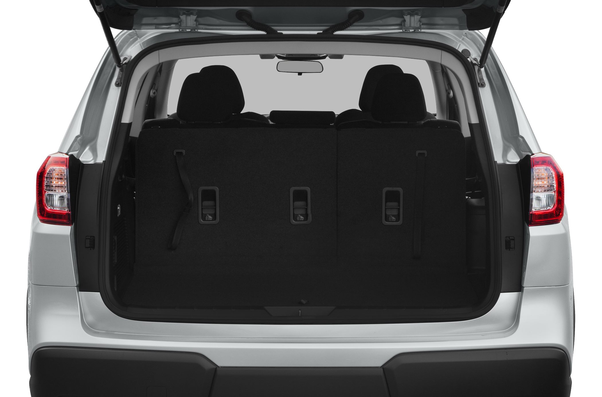 Rear trunk with folded third-row seats and tail lights.