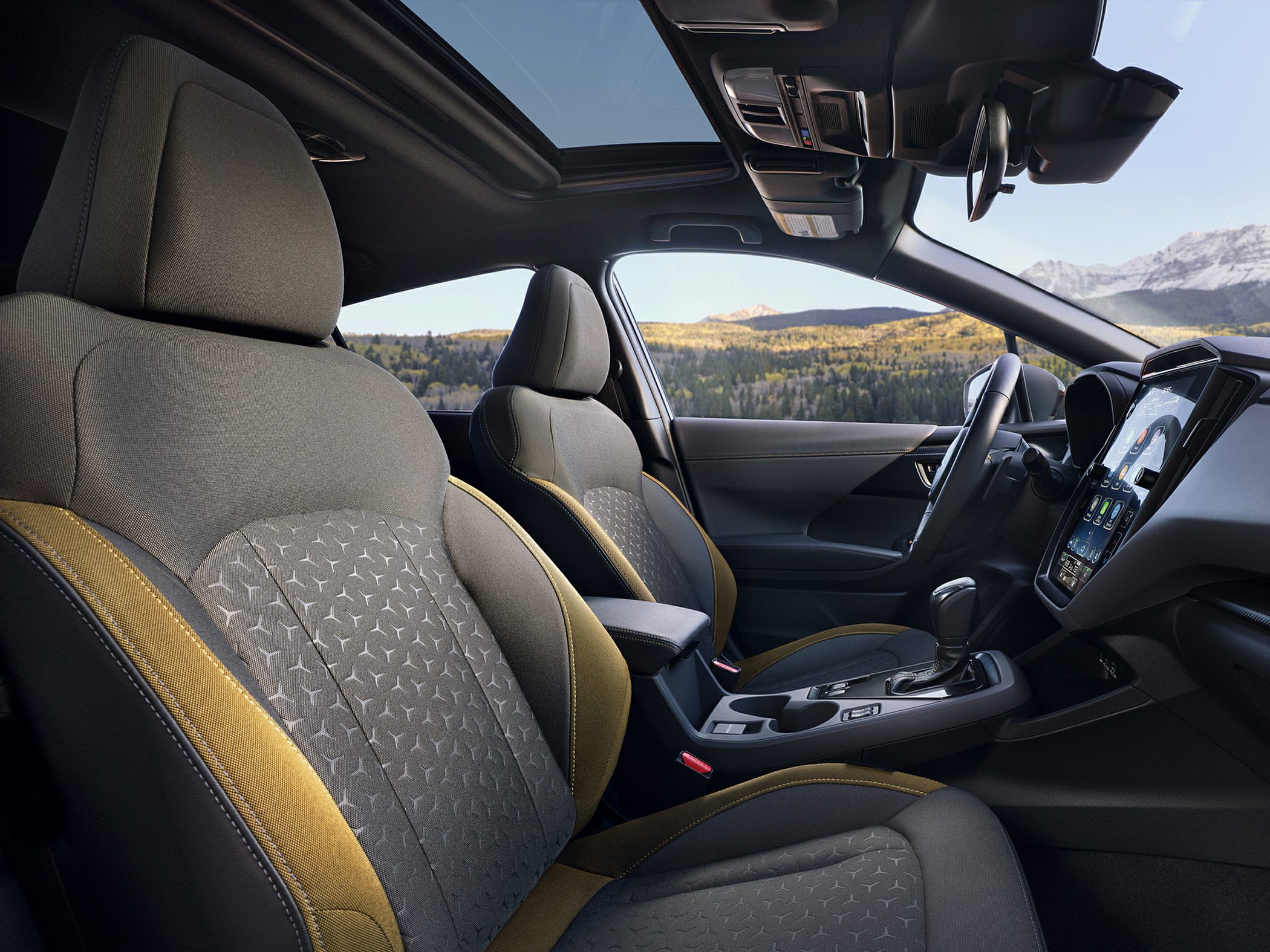 Fabric seats with decorative pattern and panoramic sunroof in modern interior