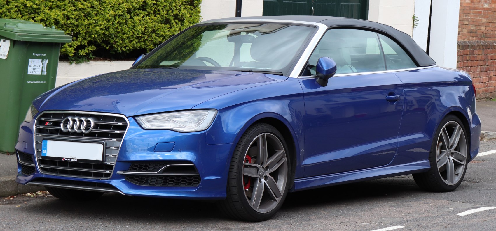 Blue convertible with alloy wheels and soft top roof