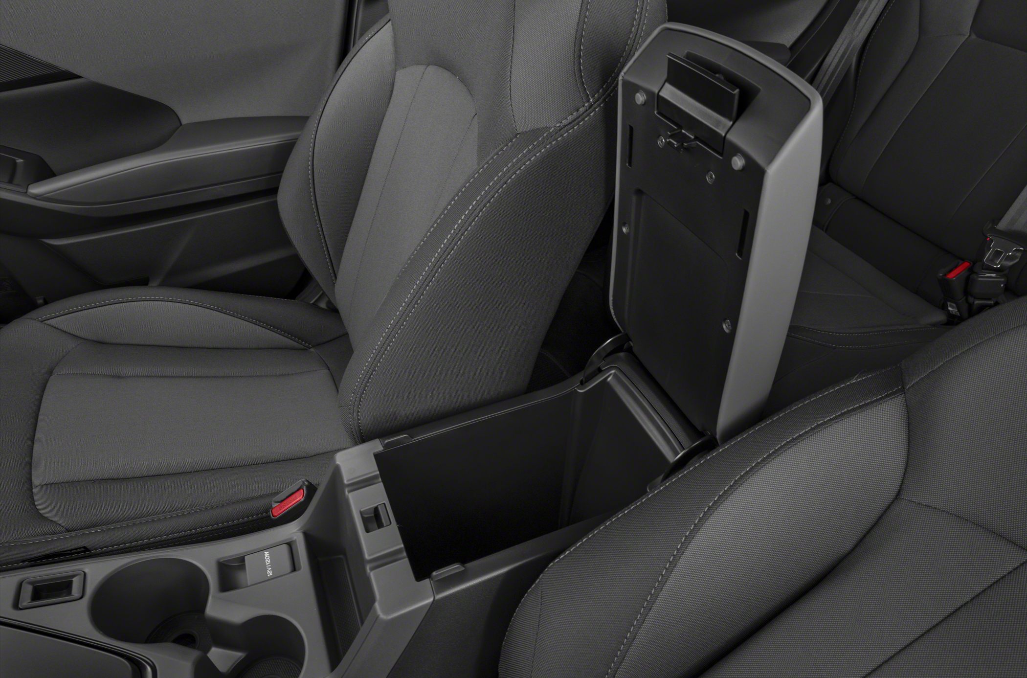 Open center console storage with fabric front seats and cup holders.
