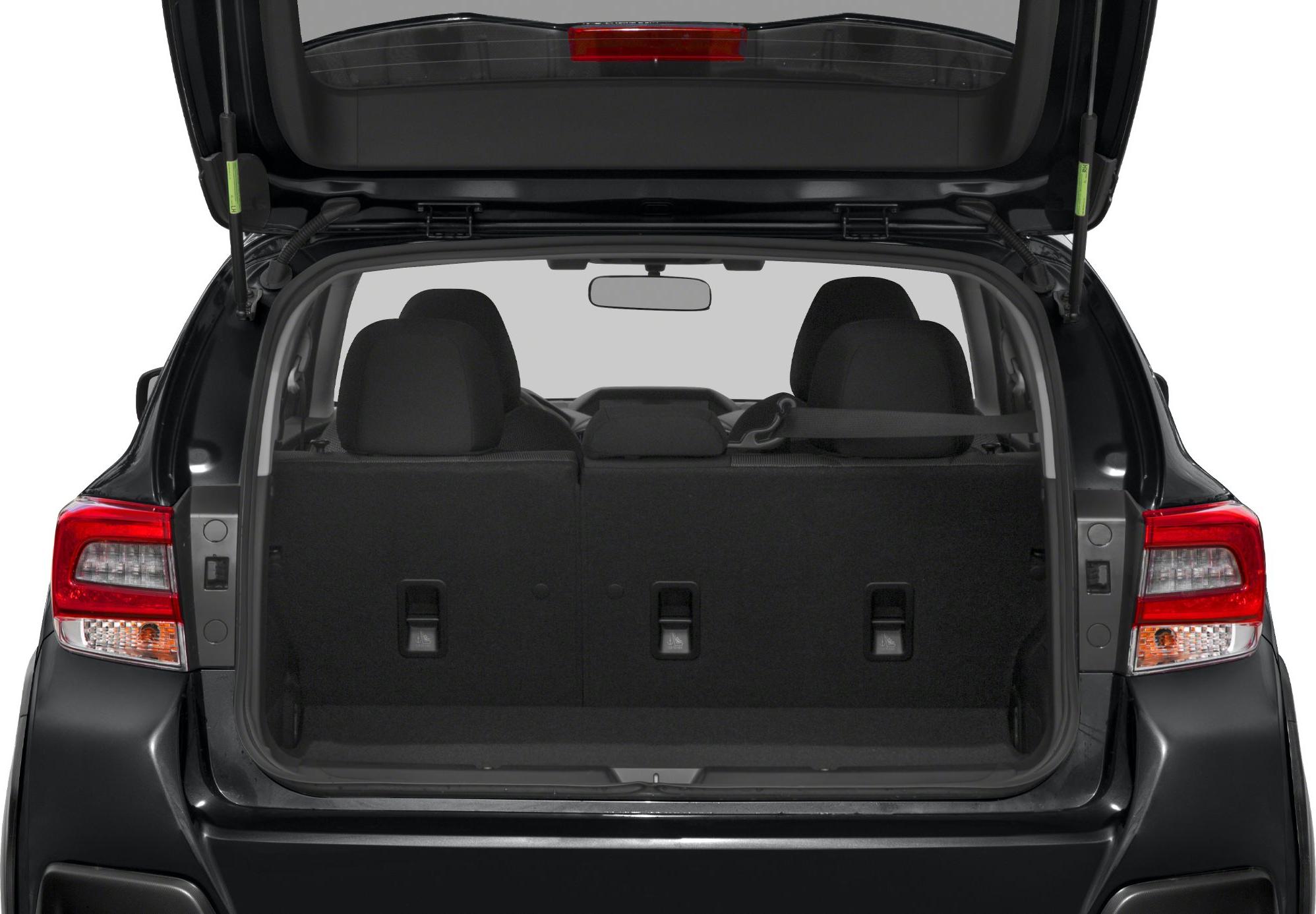 Spacious rear trunk with foldable back seats and open hatch door.