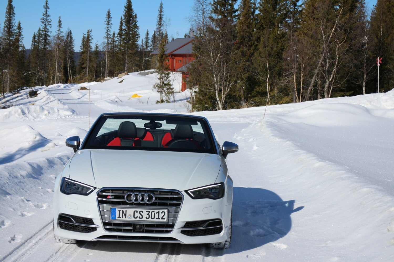Front grille and convertible black-red interior seats in snowy environment