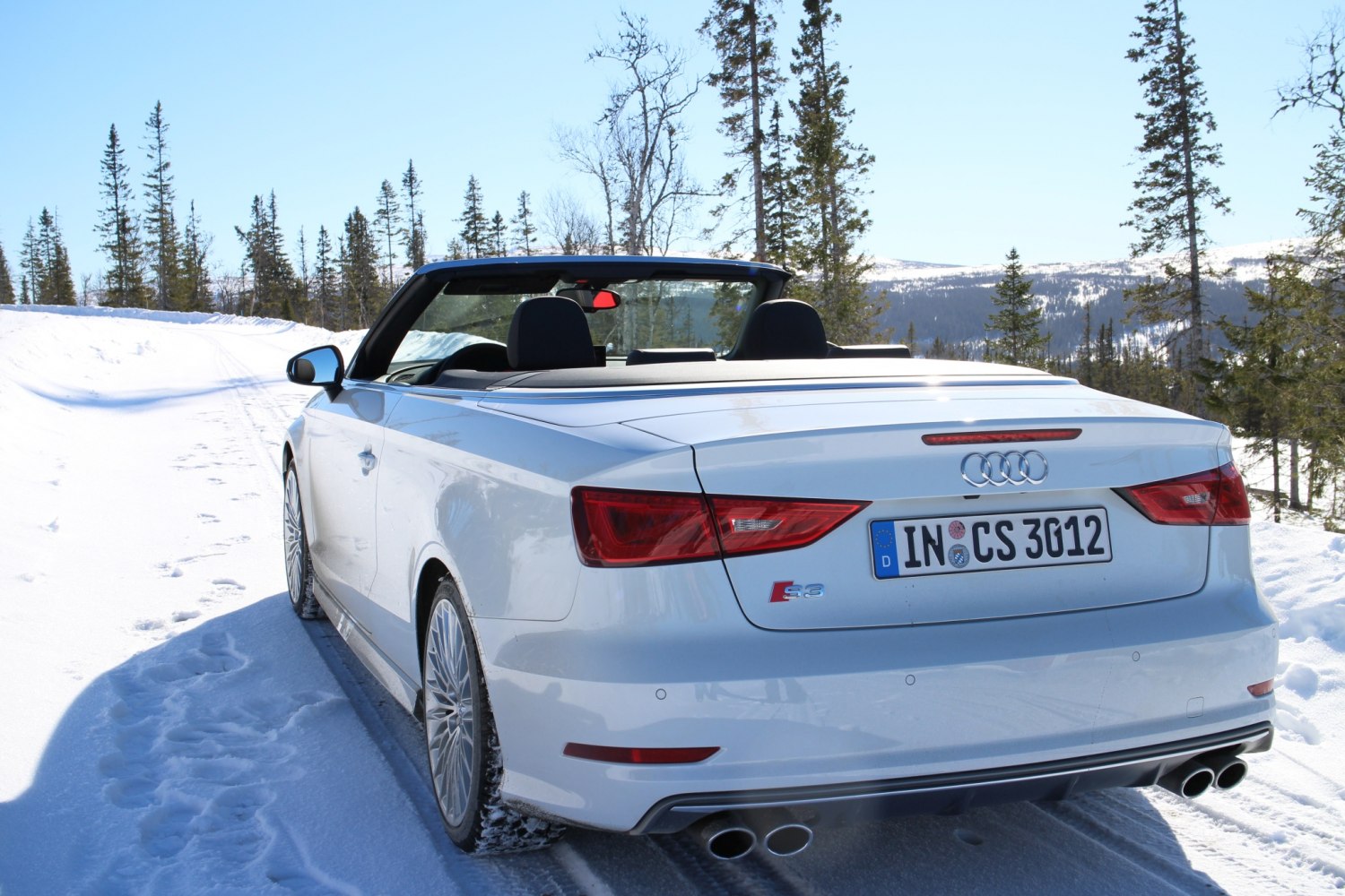 Rear view of convertible with quad exhausts in snow