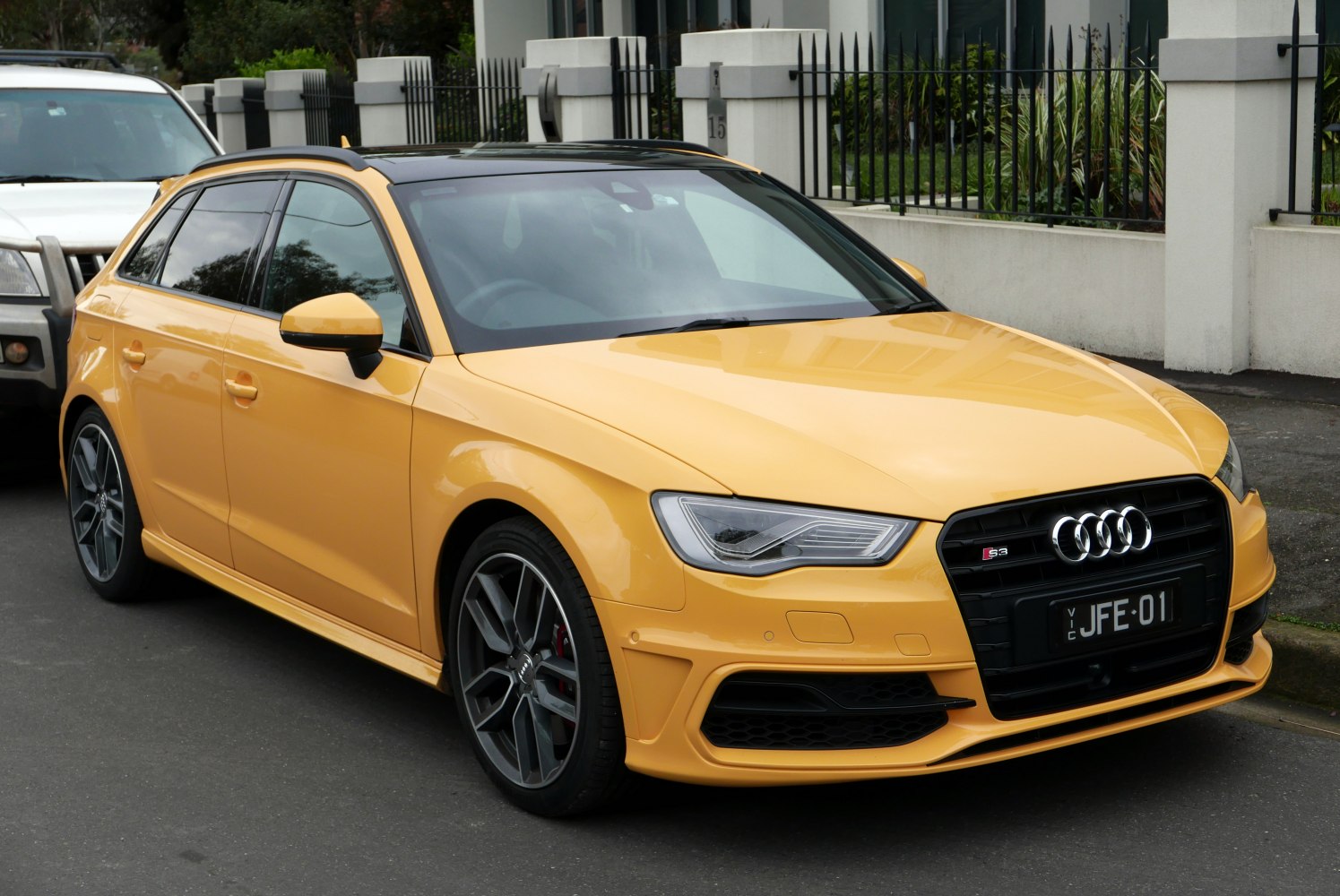 Yellow hatchback with distinctive alloy wheels and front grille