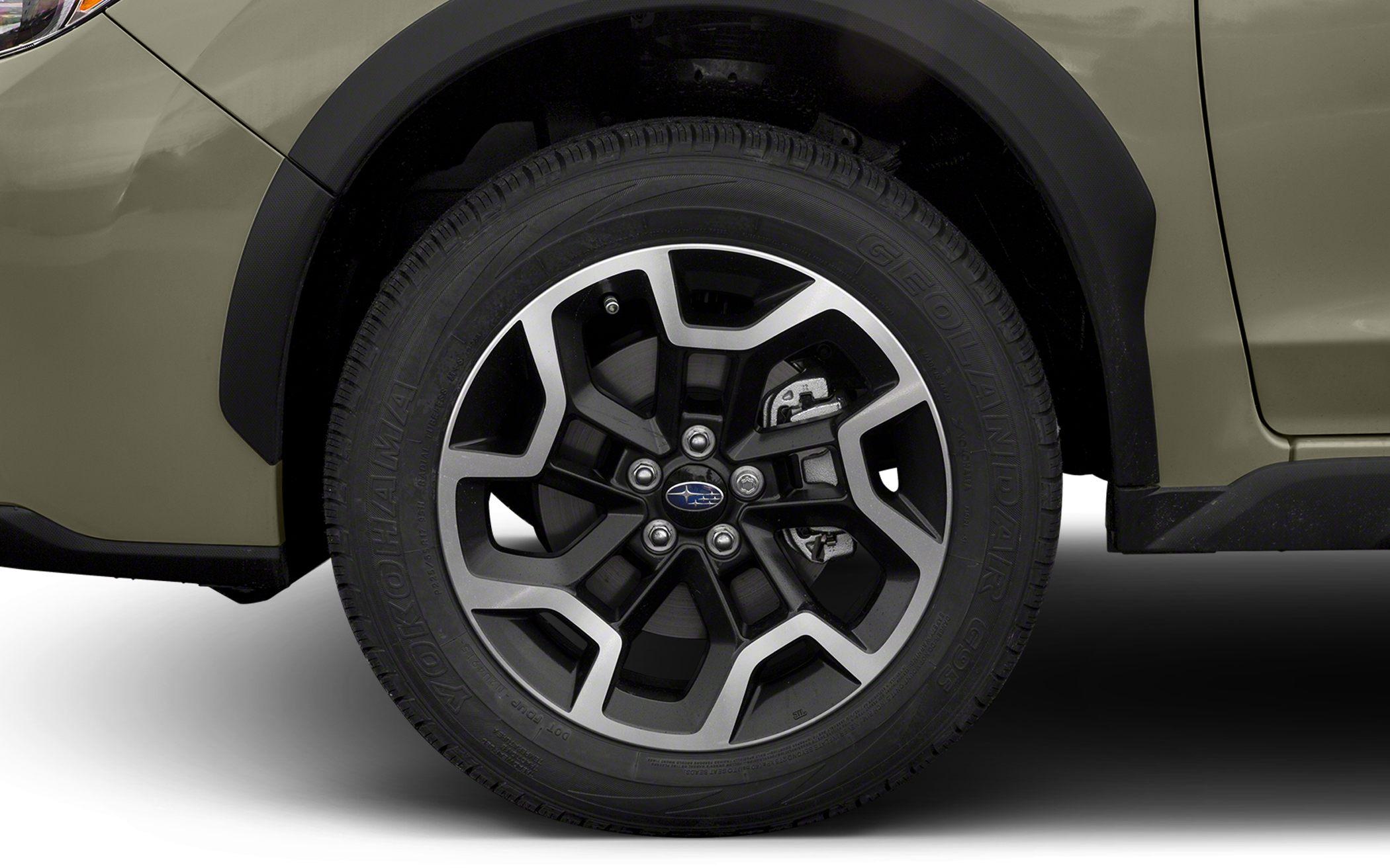 Close-up of alloy wheel and tire with brake caliper behind