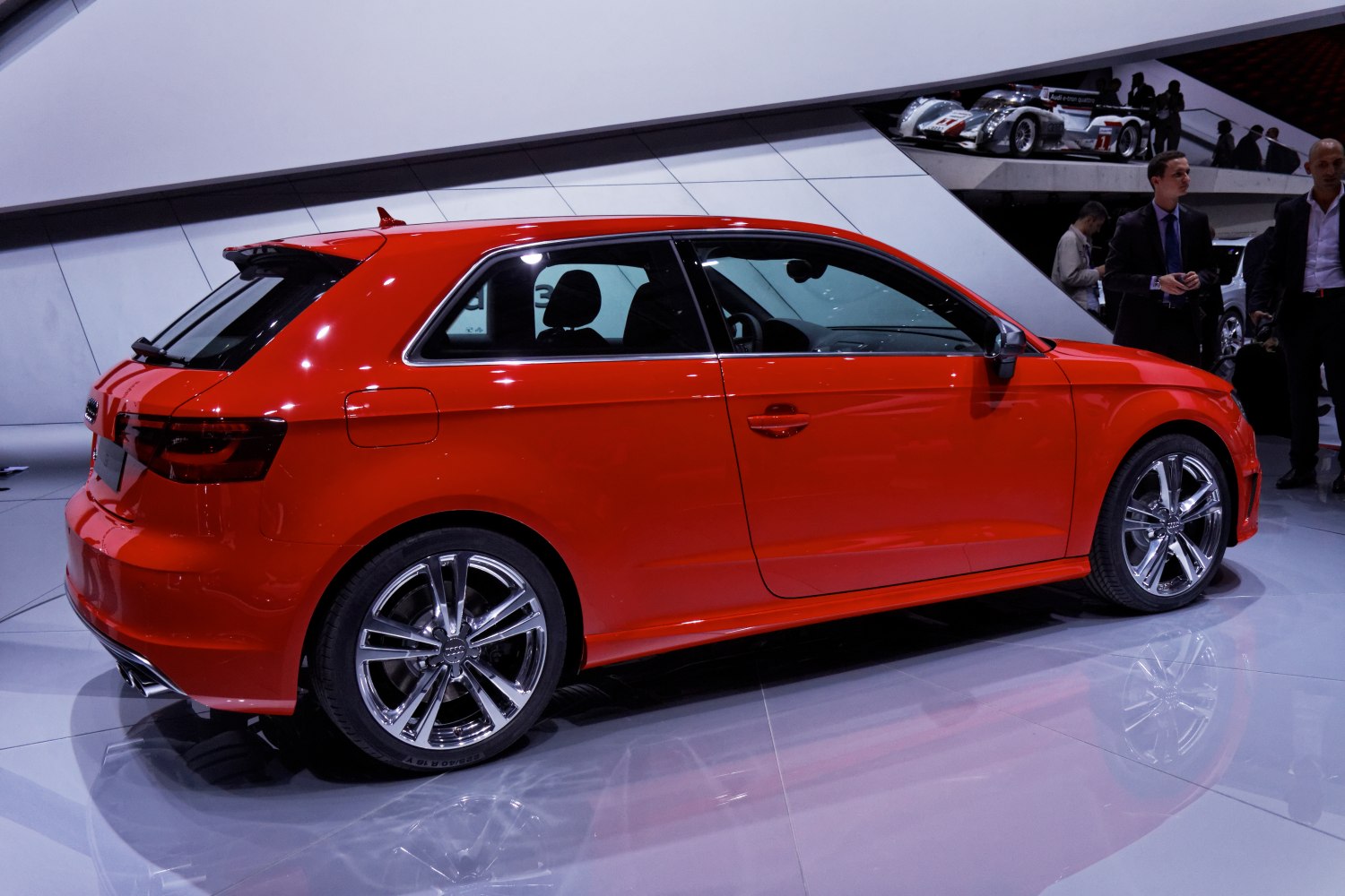 Red hatchback side view with alloy wheels