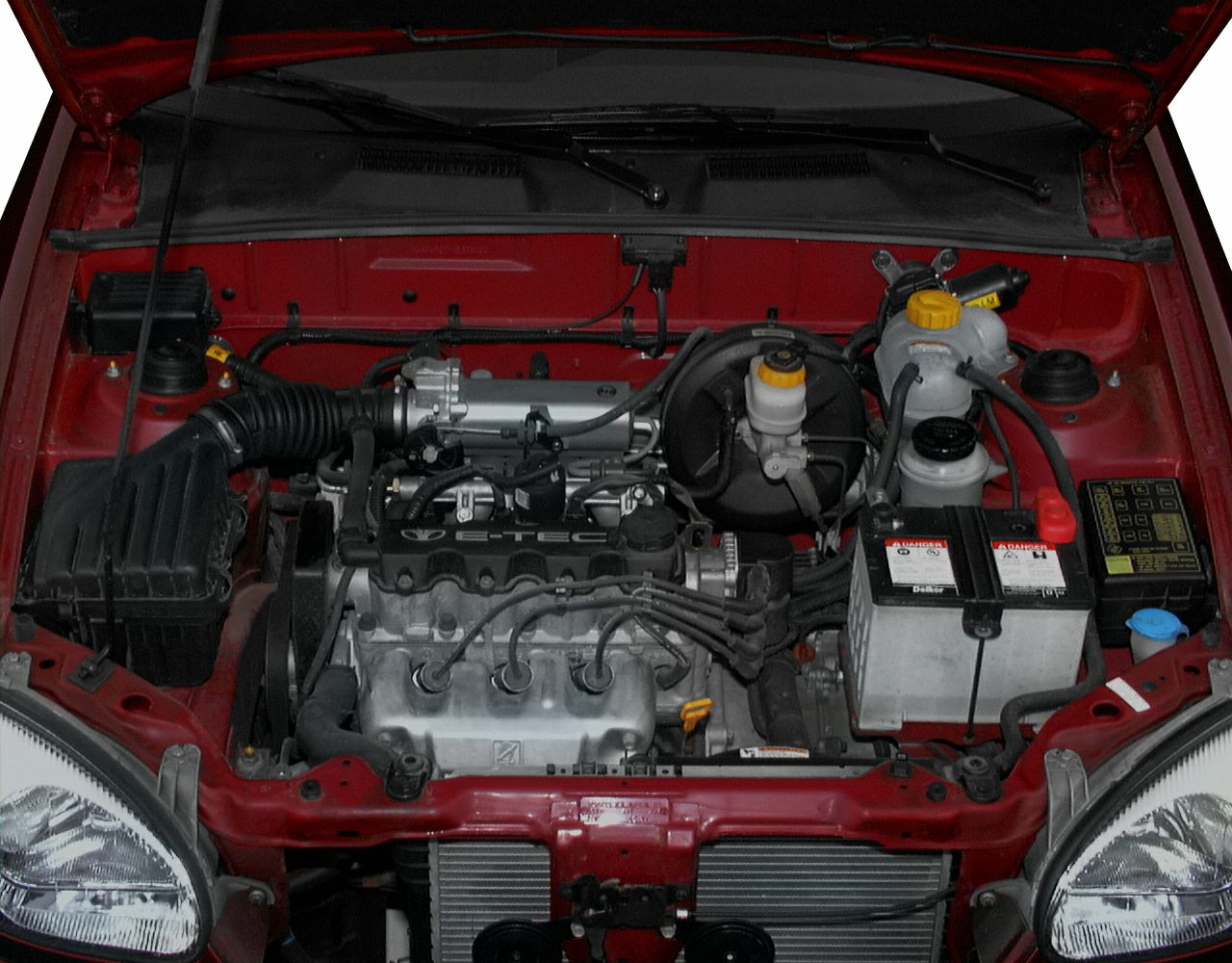 E-TEC engine bay with battery, air intake, brake, and coolant reservoirs.
