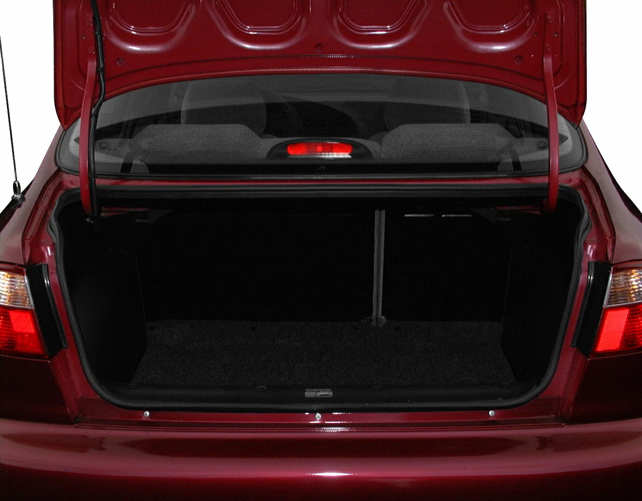 Open rear trunk with brake light and tail lights on red sedan