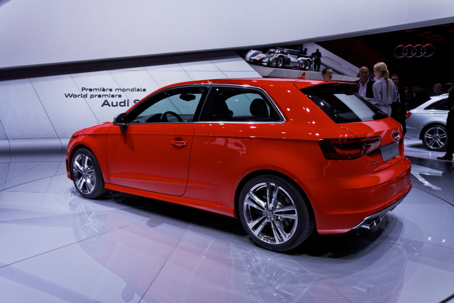 Red hatchback with sporty chrome rims and dual exhausts