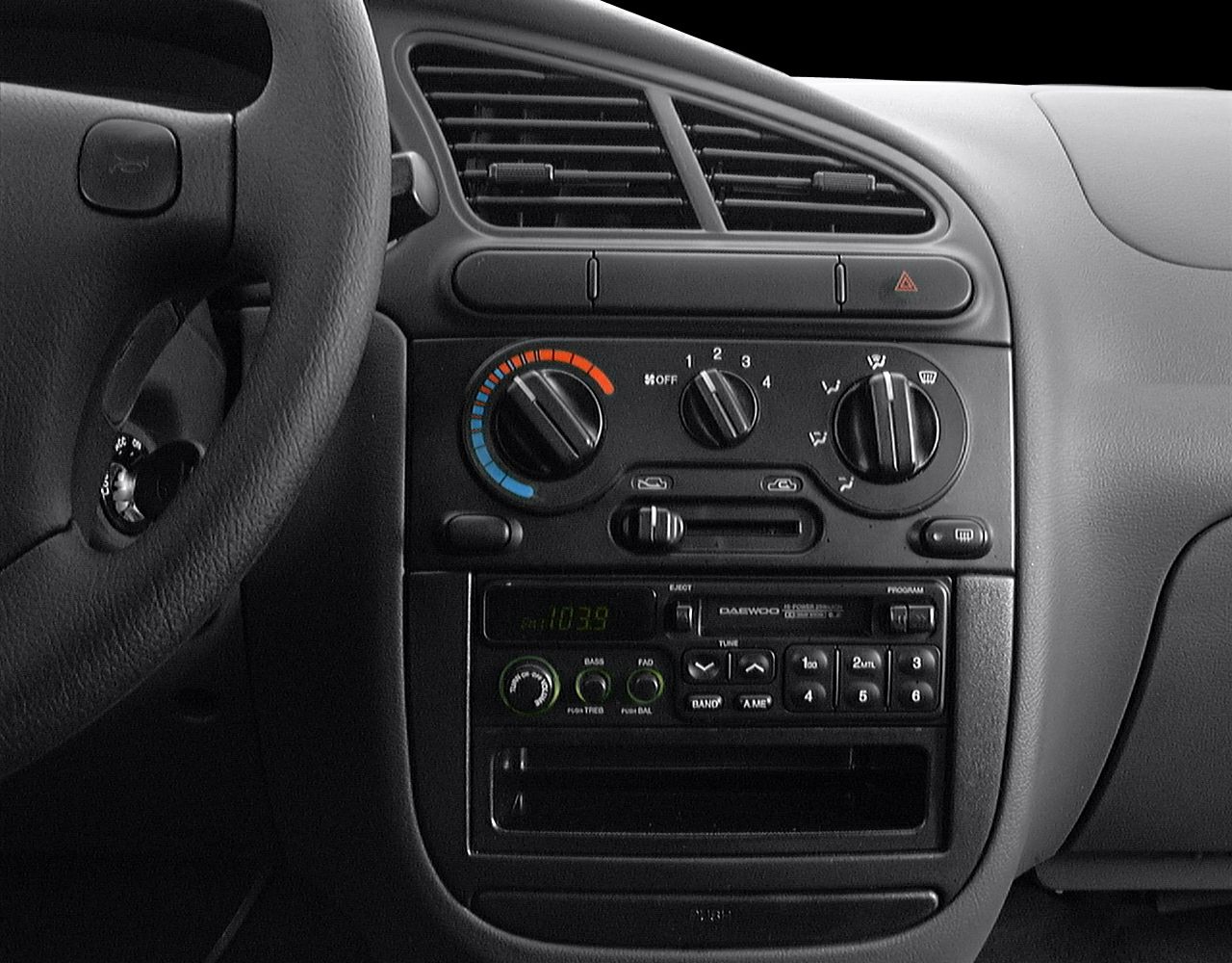 Dashboard with climate controls, air vents, and radio system