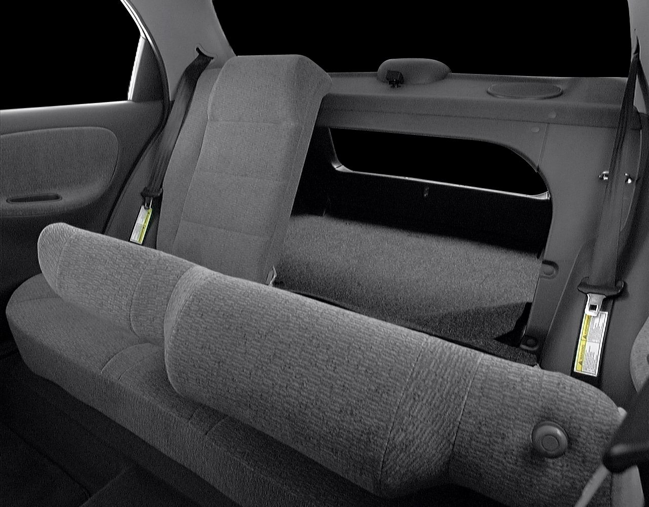 Fold-down rear bench seat with pass-through opening and seat belts