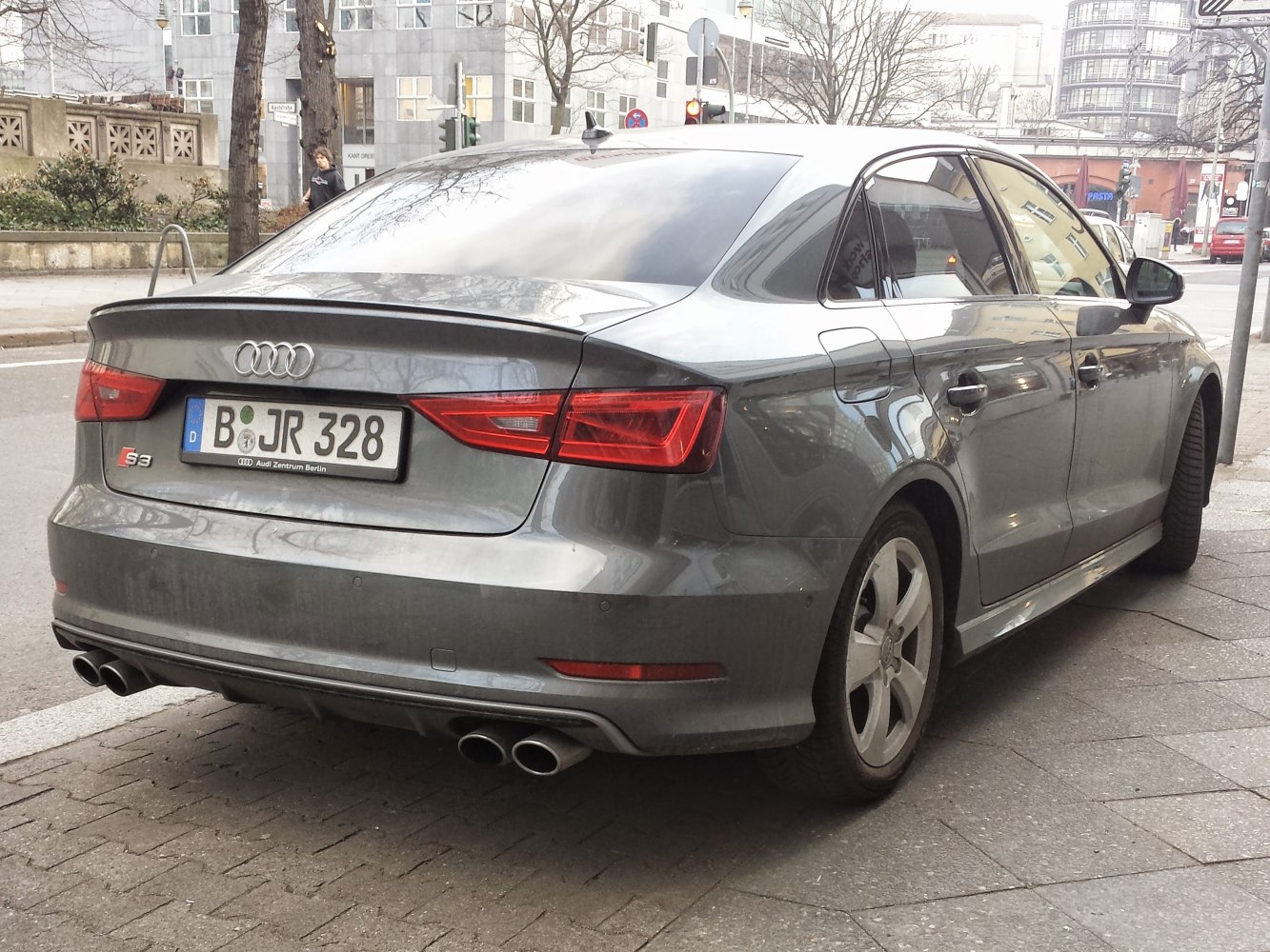 rear view of sedan with quad exhaust and sporty taillights