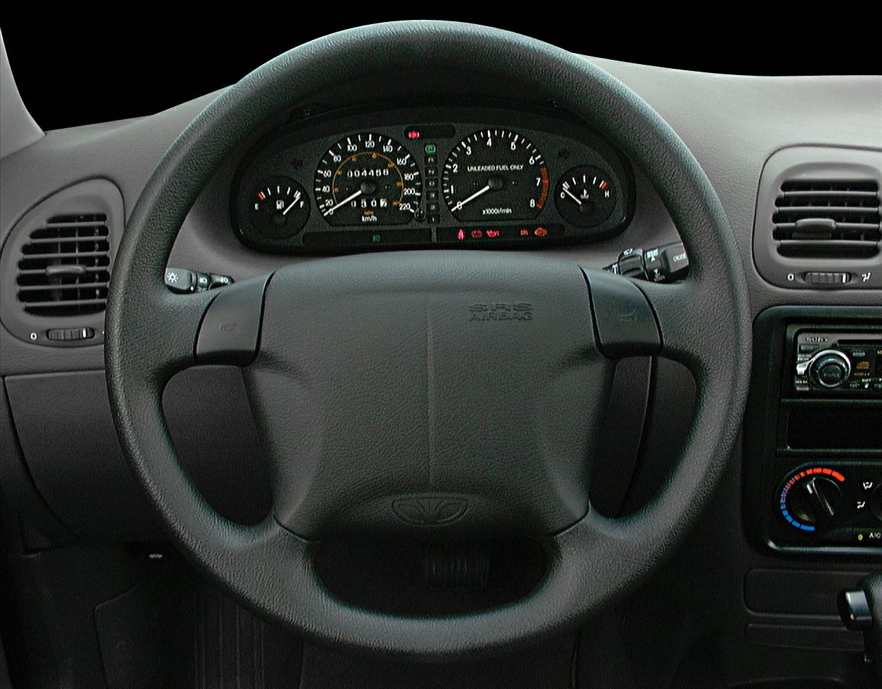 Dashboard and steering wheel with gauges and controls