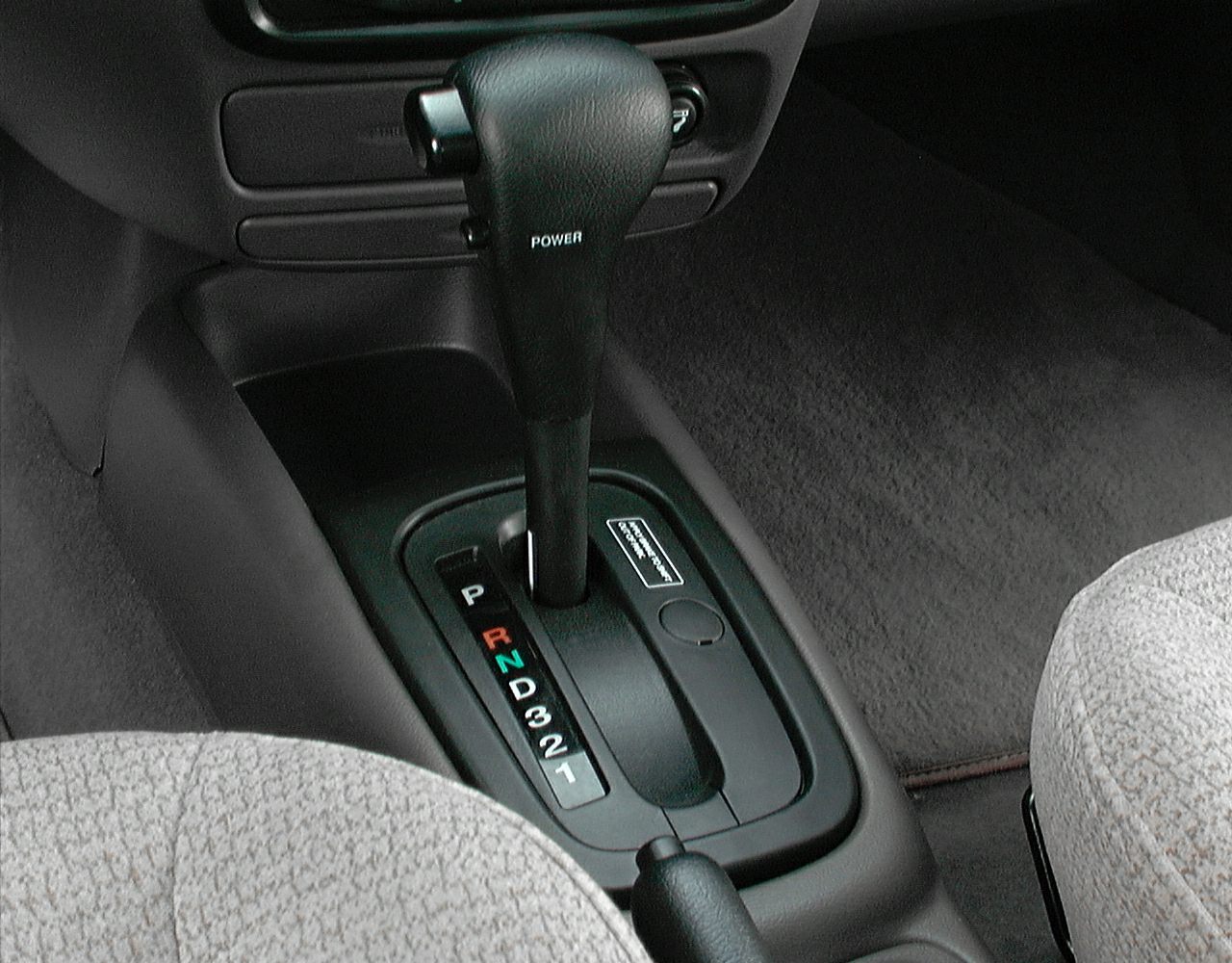 Automatic gear shift lever with detailed gear positions, fabric seats