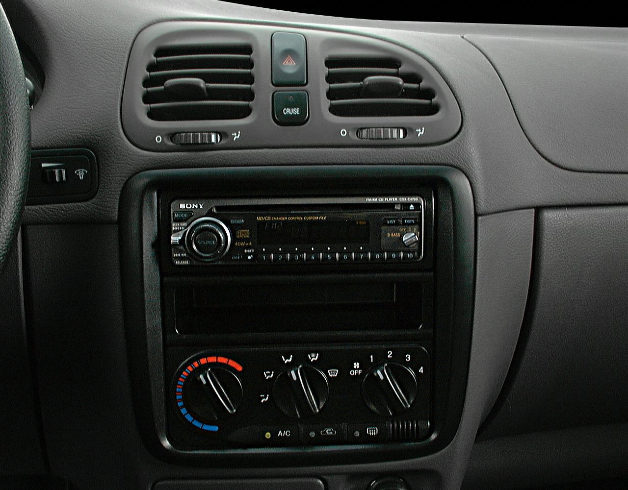 Center console with stereo, air vents, and manual climate controls