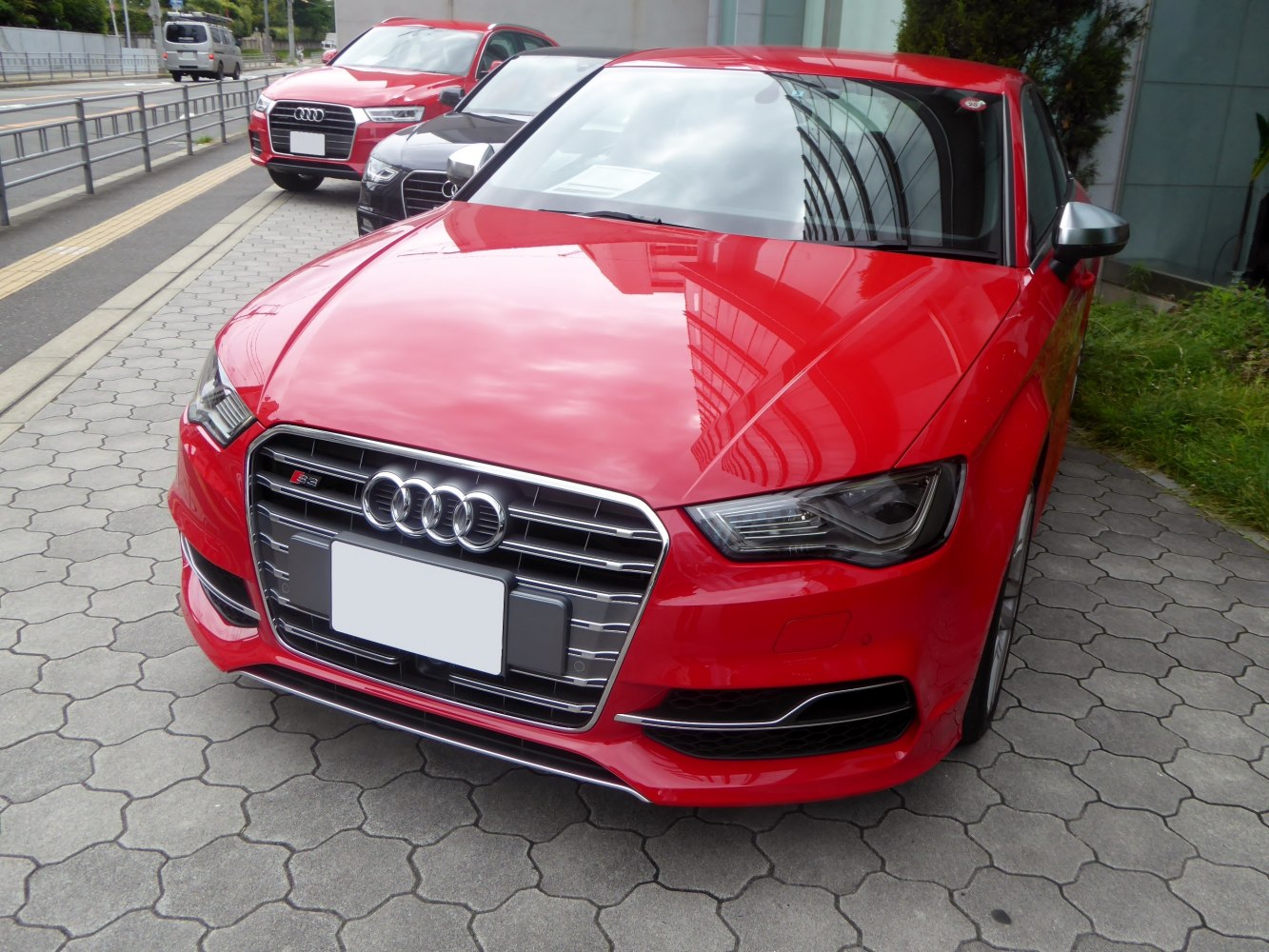 Close-up of front grille and headlights of a sporty red sedan