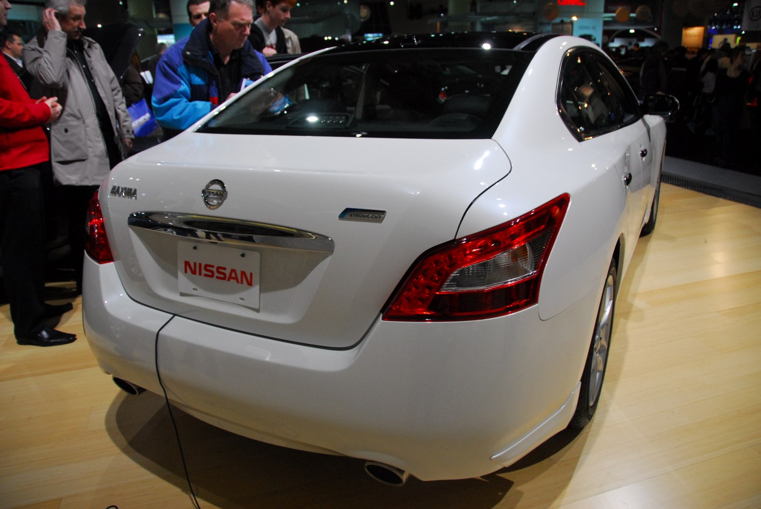 Rear view with distinctive taillights and trunk of a modern white sedan