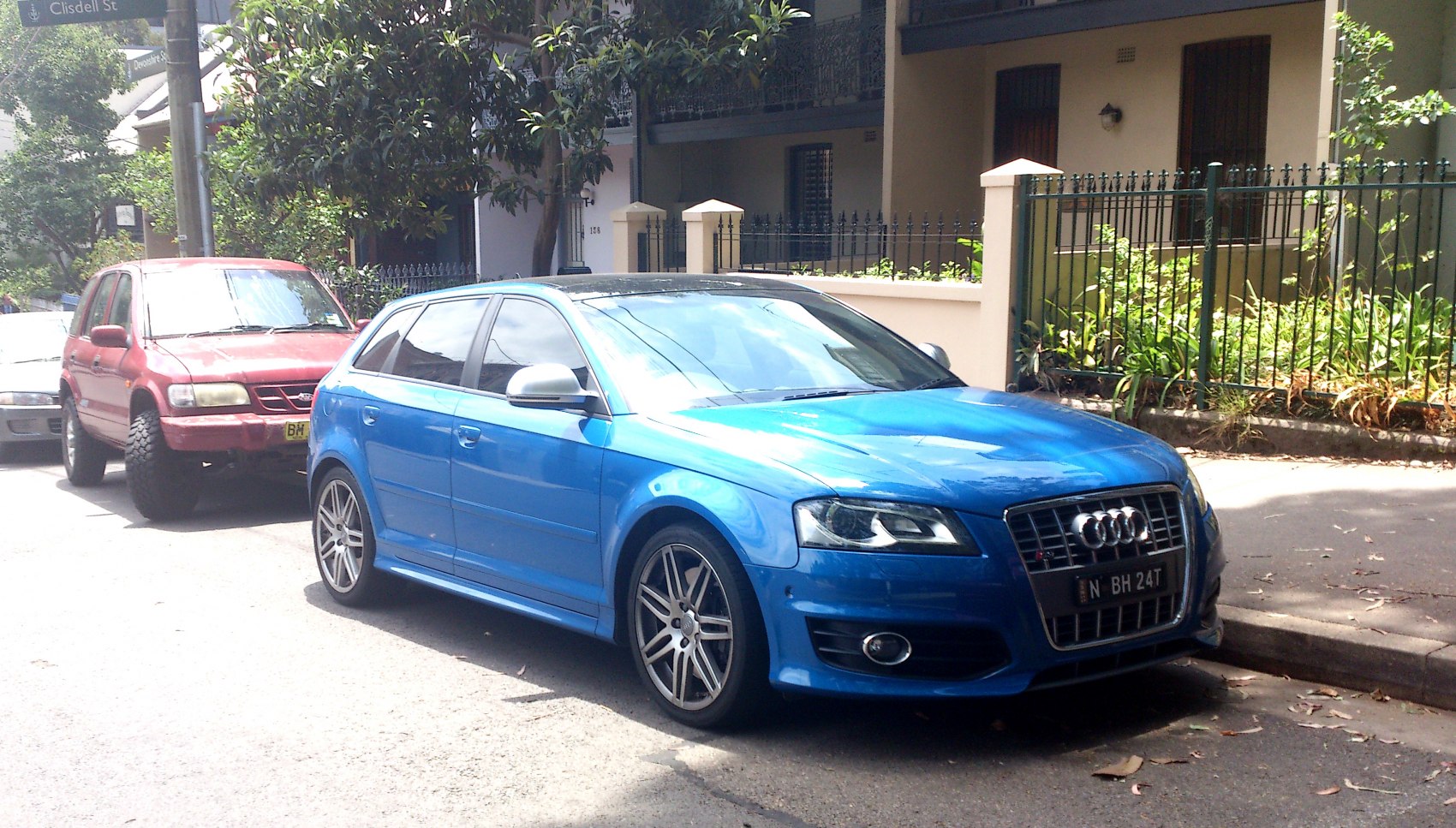Blue sporty hatchback with grille and alloy wheels