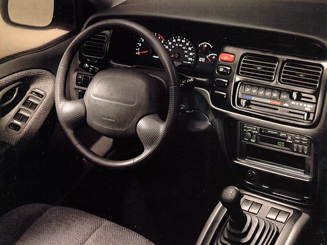 Dashboard, steering wheel, and manual gear shift interior details