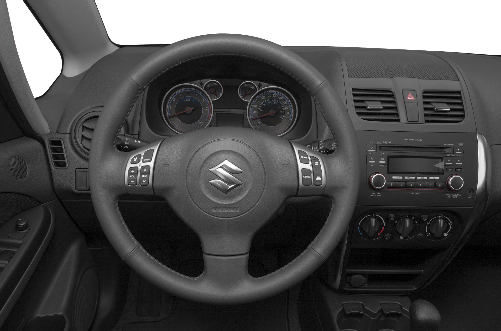 Steering wheel with controls and dashboard with instrument cluster and audio system