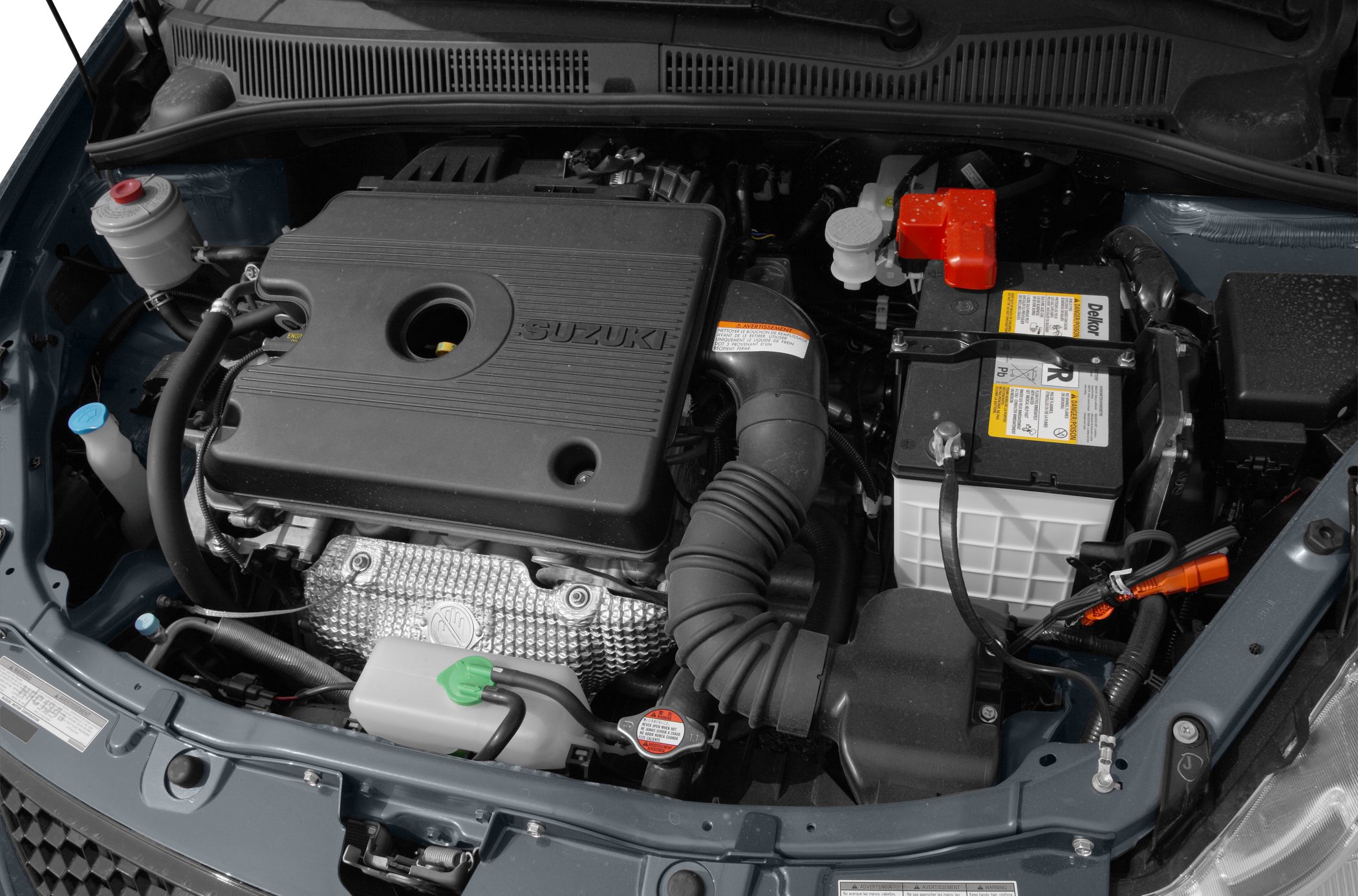 Engine bay with engine cover and battery placement