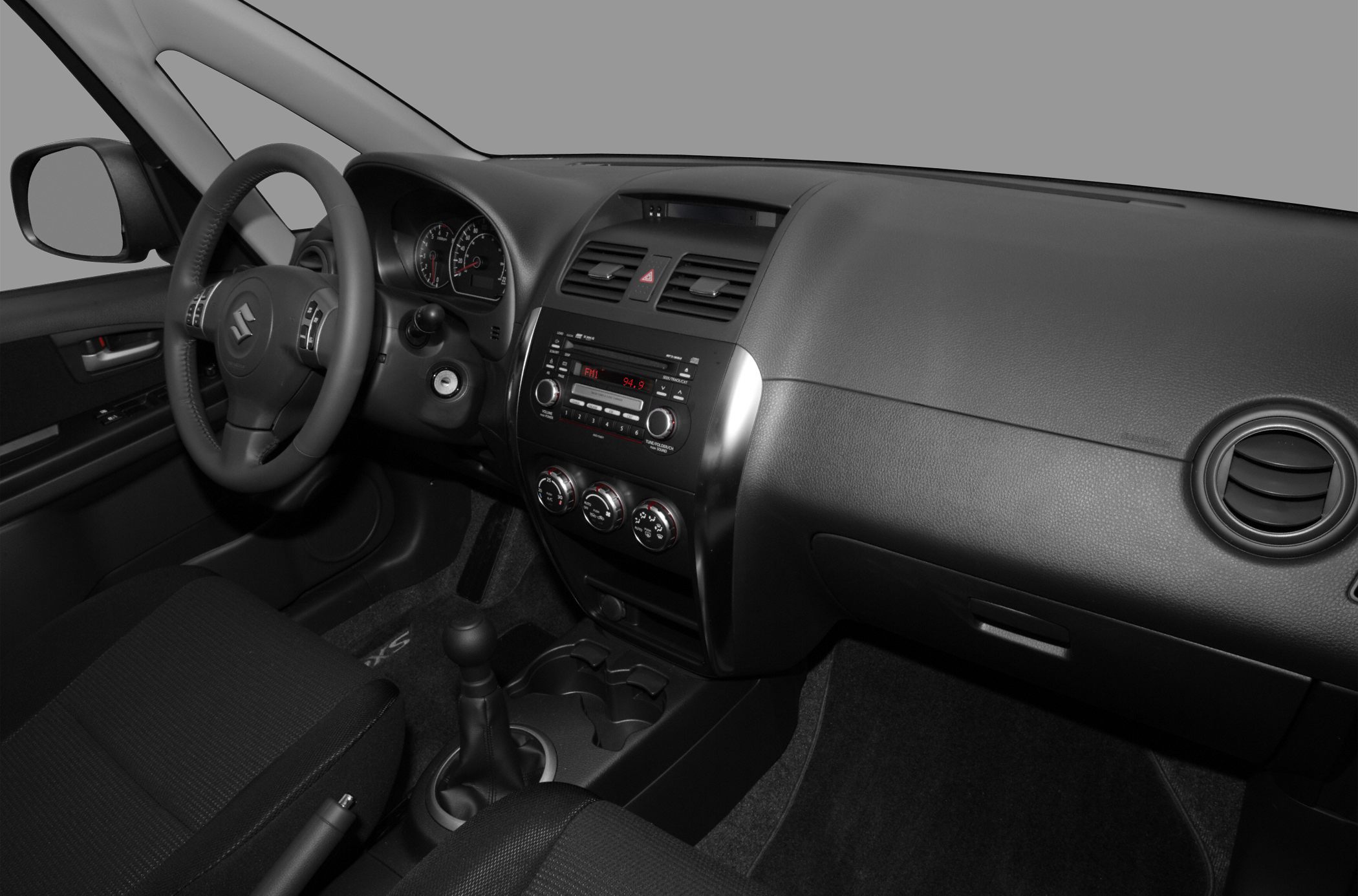 Dashboard with steering wheel, center console, and manual gear shift
