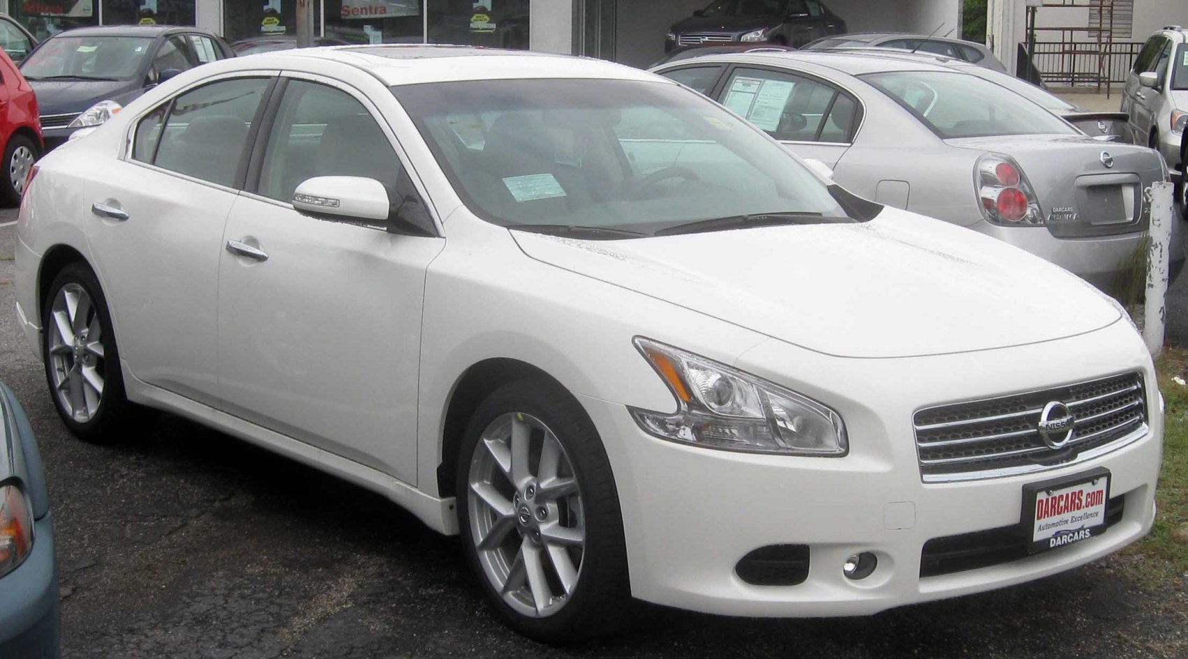 White sedan with sleek front grille and aerodynamic side profile