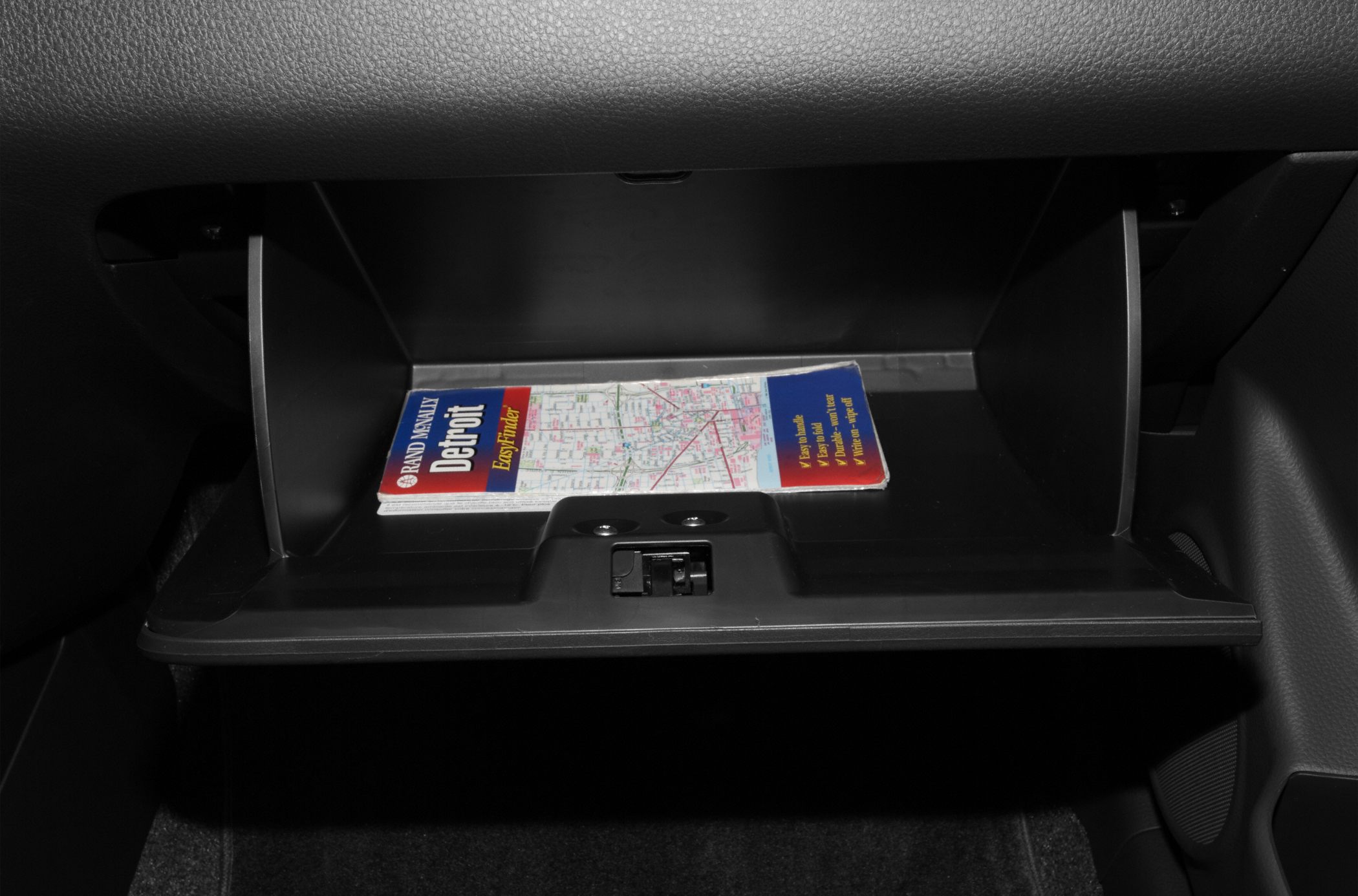 Open glove box with a map inside