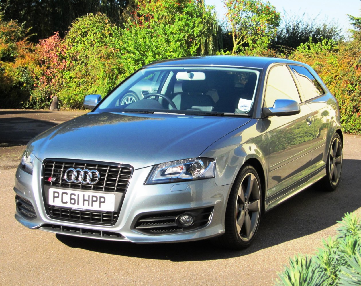 Silver sport hatchback front view with LED headlights and five-spoke alloy wheels