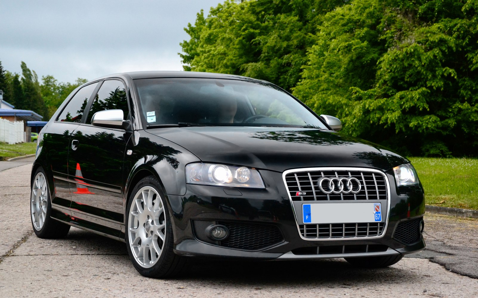 front view, silver grille, multi-spoke alloy wheels, black hatchback