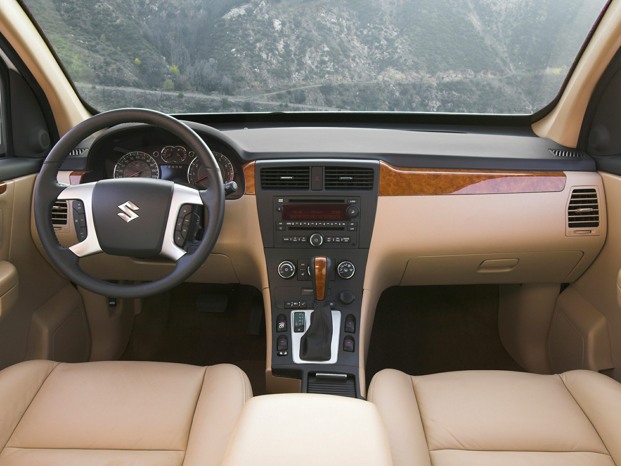 Beige interior with wood trim dashboard, steering wheel, and center console layout