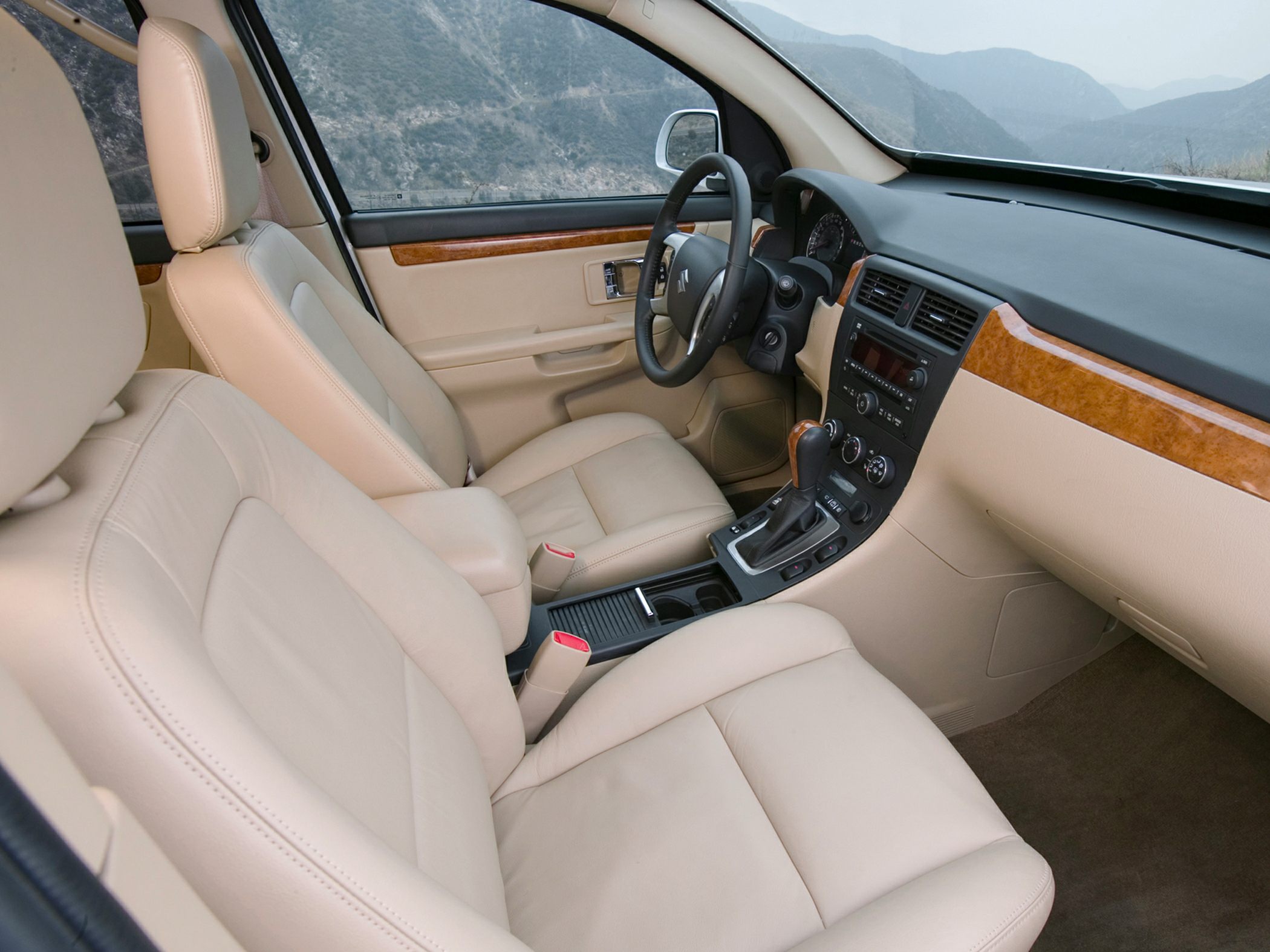 Beige leather seats with wood trim and modern dashboard
