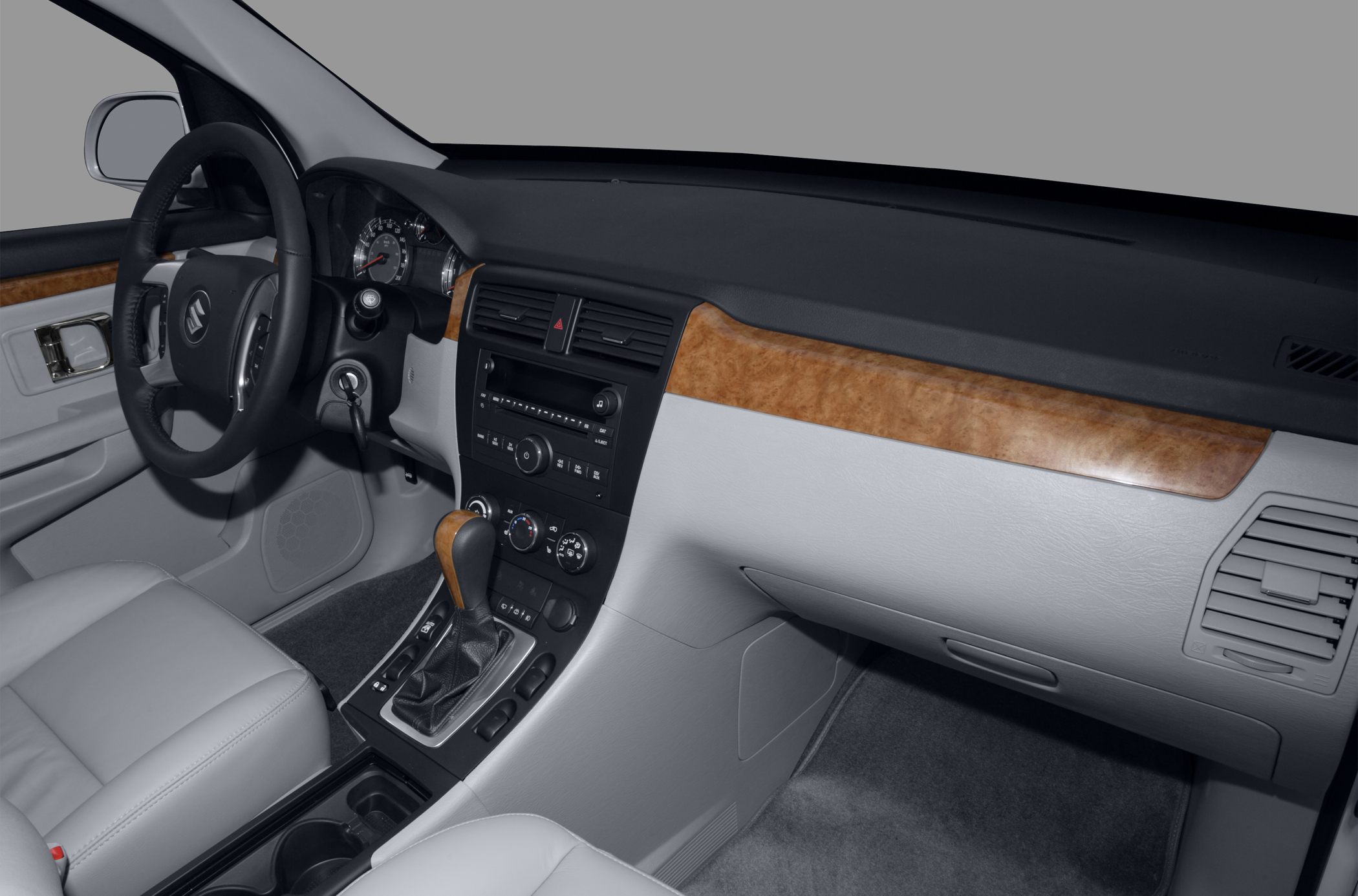 Dashboard and gear shift with wood trim and leather seats.