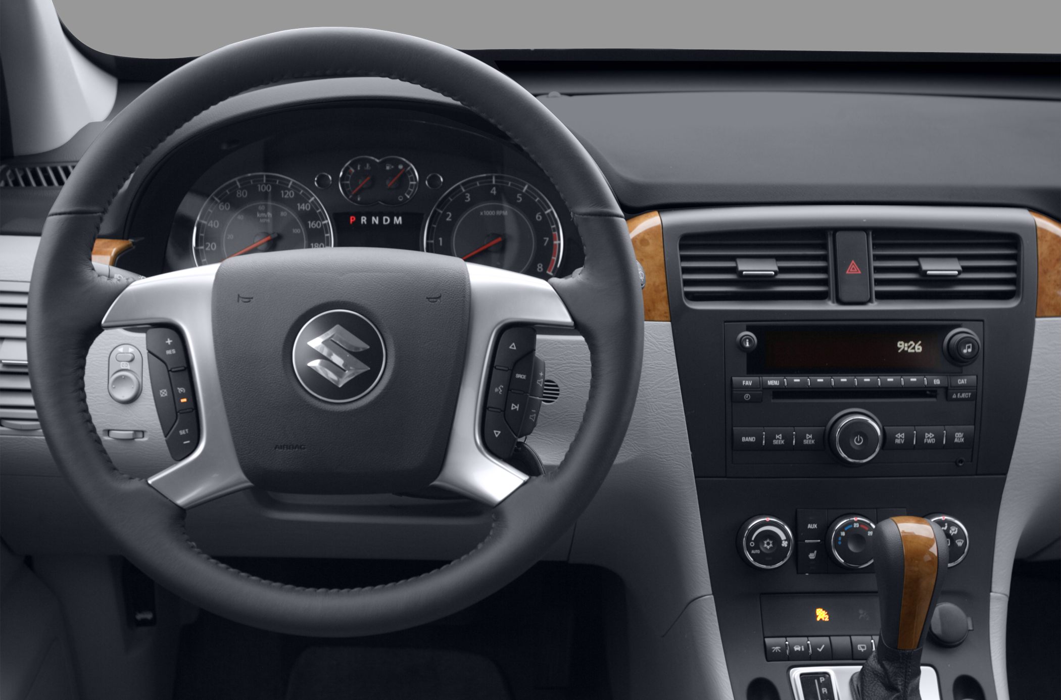 Dashboard with steering wheel controls and wood-trimmed center console