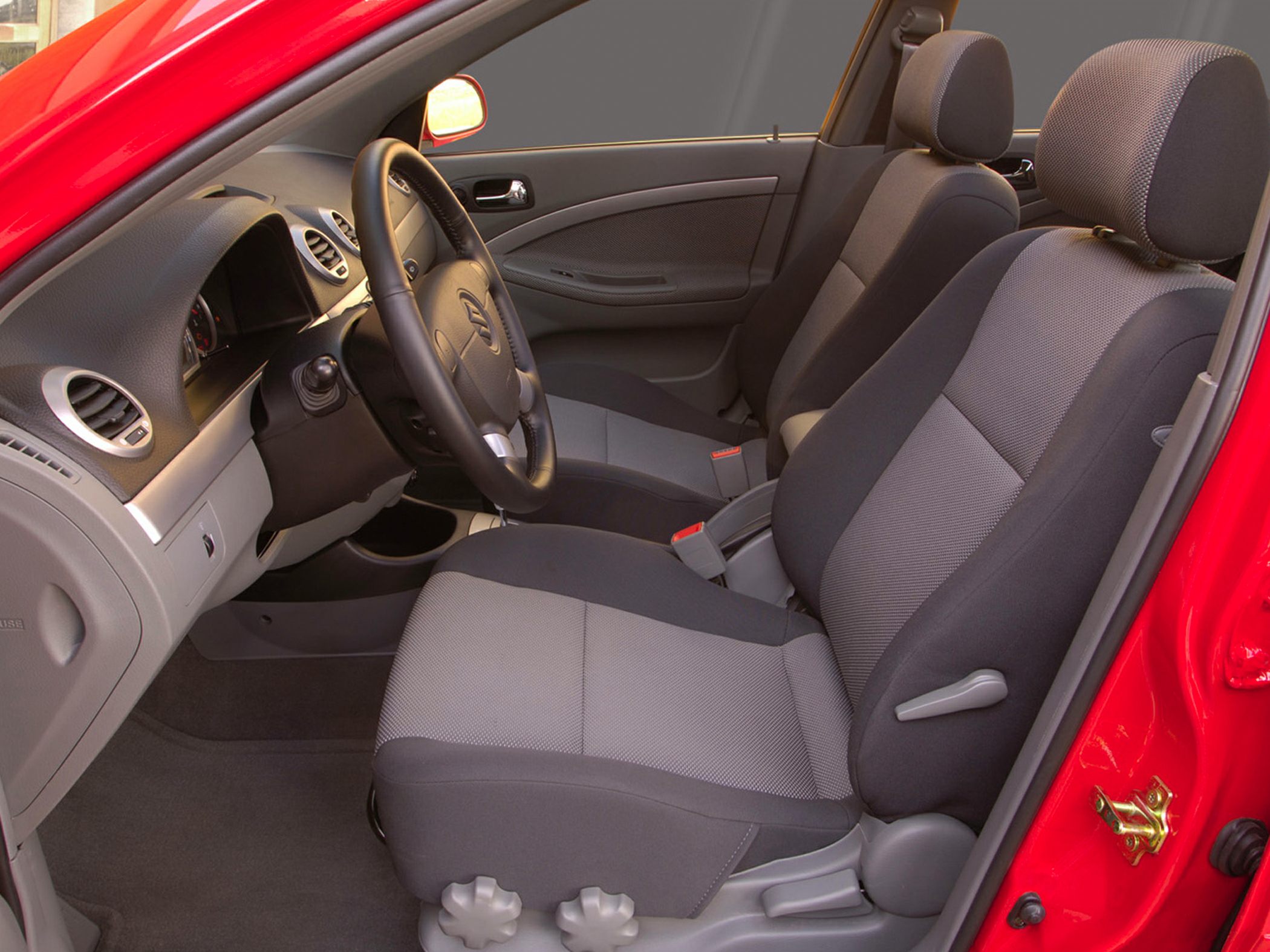 Front seats and dashboard interior with fabric upholstery and steering wheel