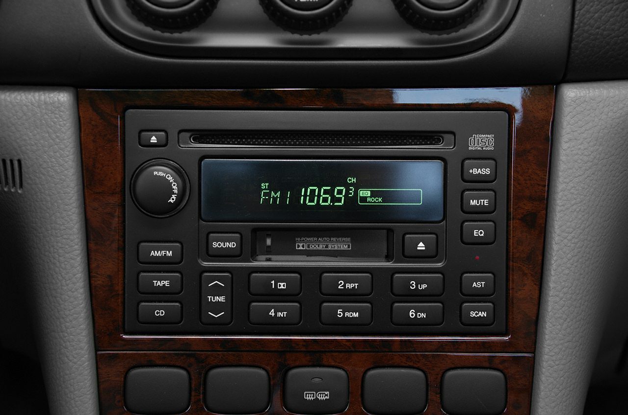 Car stereo system with cassette, CD player, and FM radio display