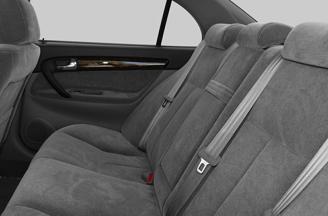 Rear seat upholstery and seatbelt details in a car interior
