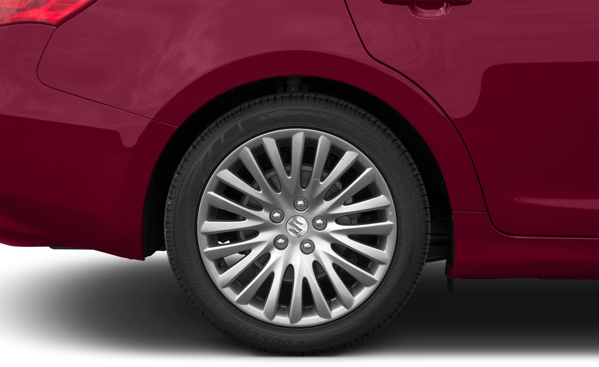 Close-up of rear alloy wheel and red car body section