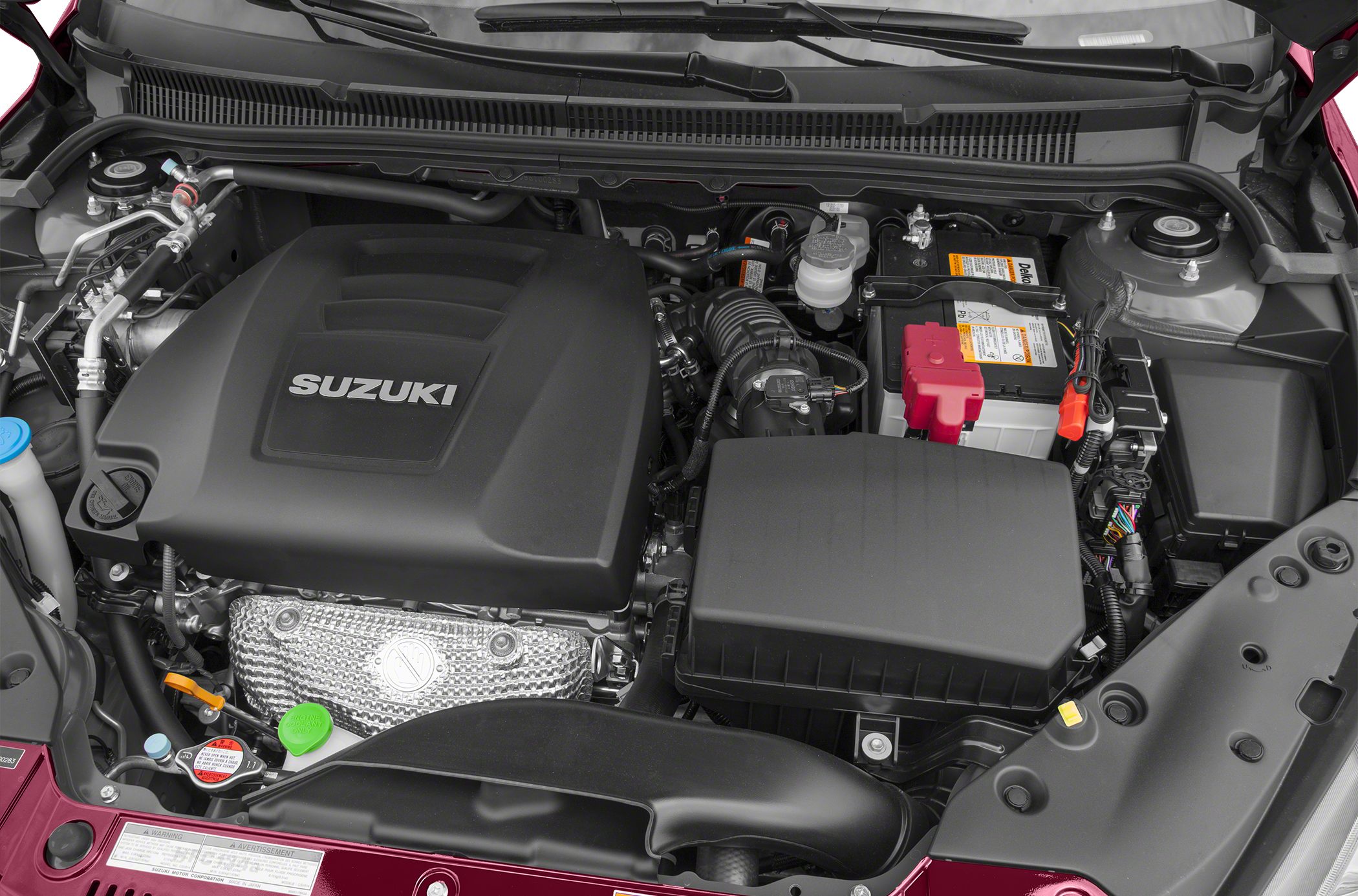 Engine bay with Suzuki-branded engine cover and components